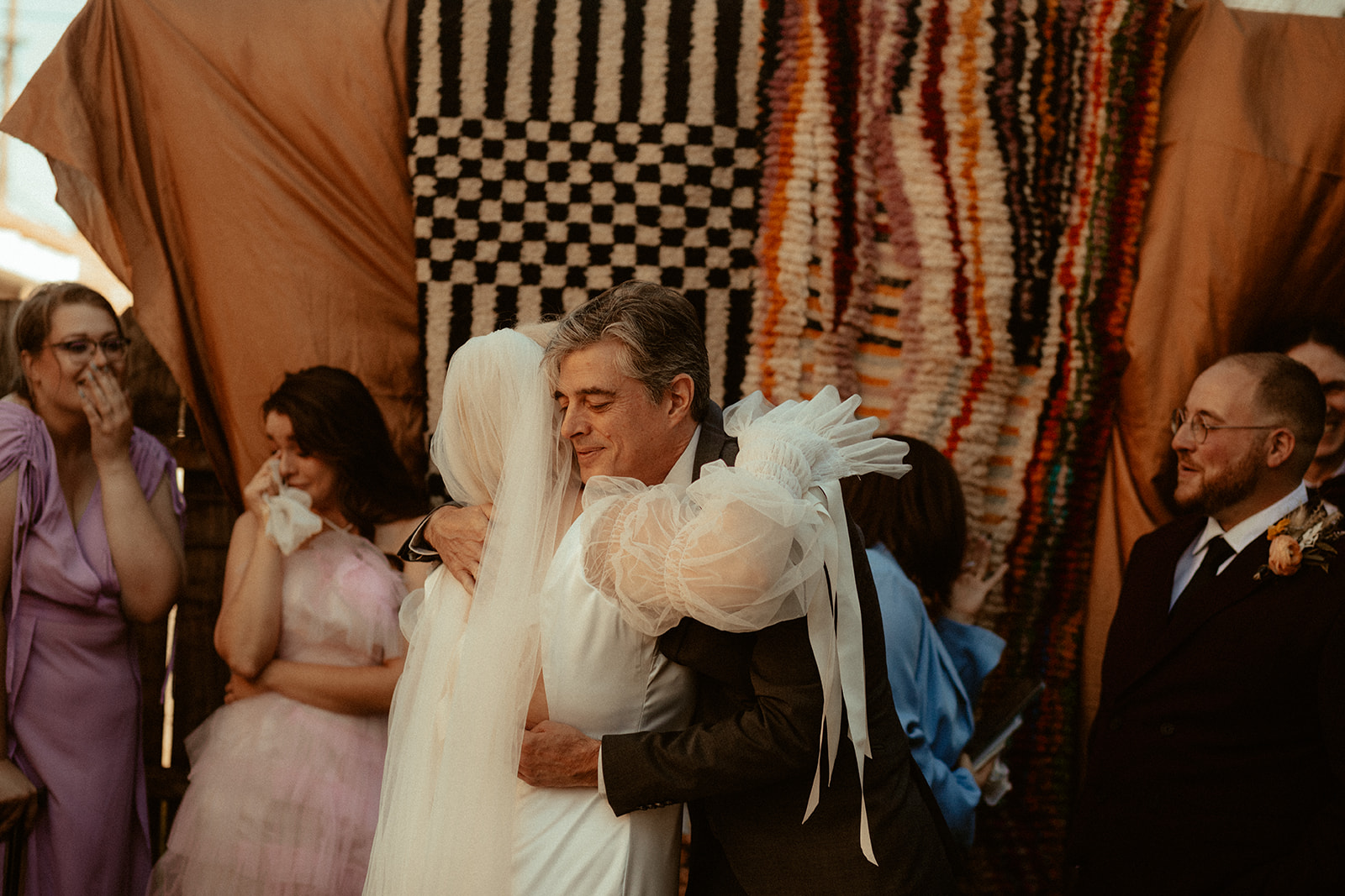 dad hugging bride during wedding ceremony