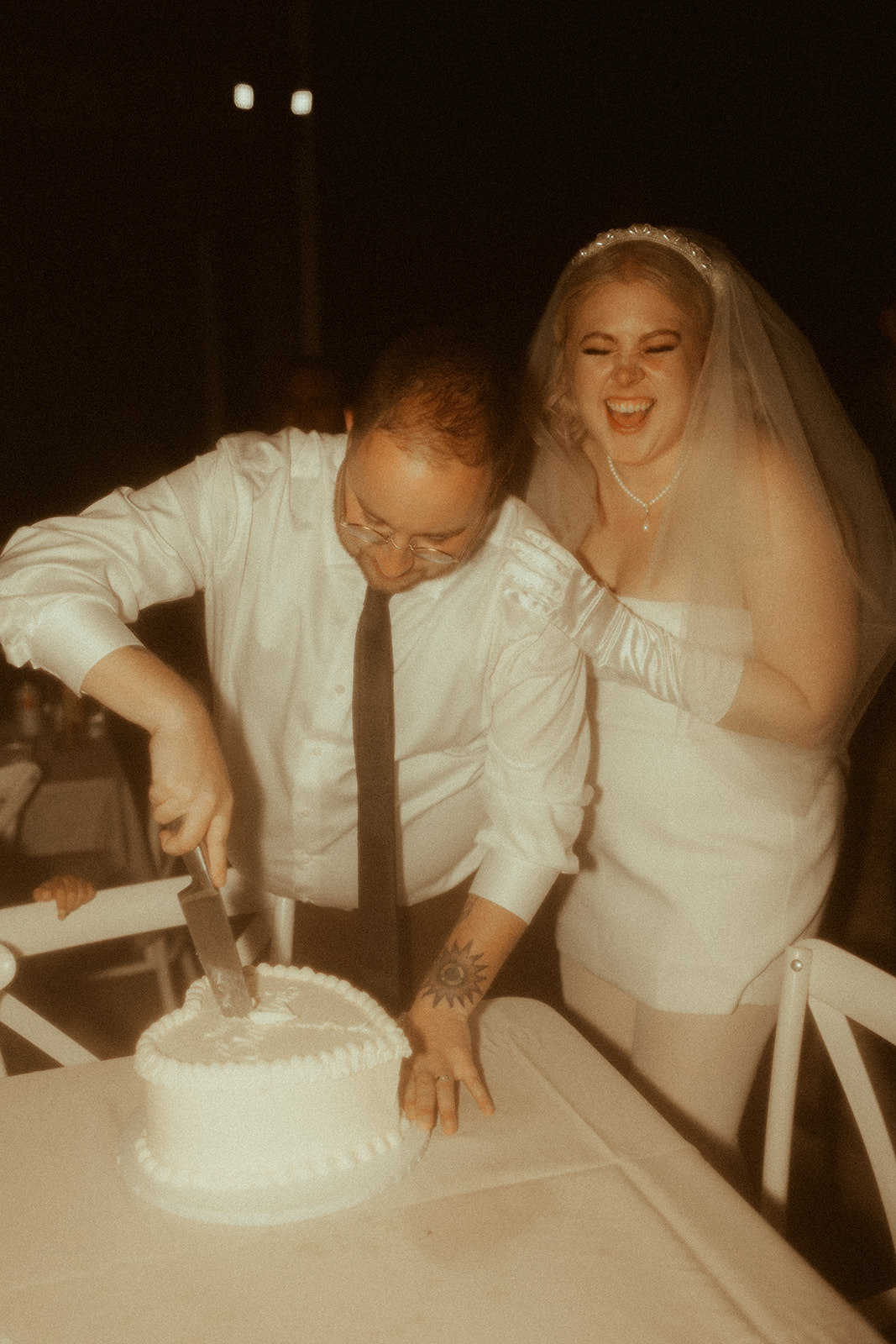 groom cutting vintage heart wedding cake