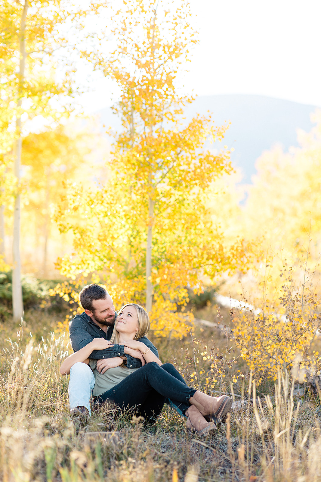 Couple in Colorado Fall color mountain setting engagement portrait