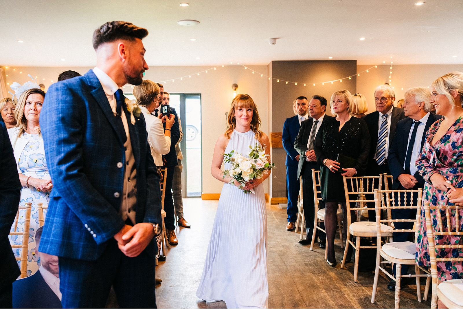 The Chequers Inn Wedding Photography - bridesmaid walking down the wedding aisle