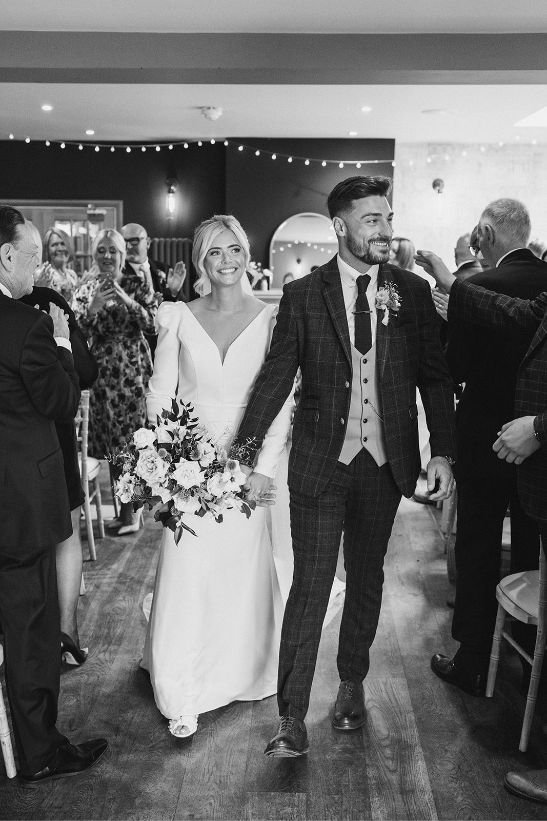 The Chequers Inn Wedding Photography - the bride and groom walking down the aisle as a newly married couple