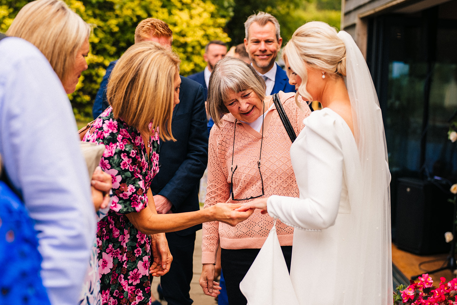 The Chequers Inn Wedding Photography - the bride showing off her wedding ring to the wedding guests