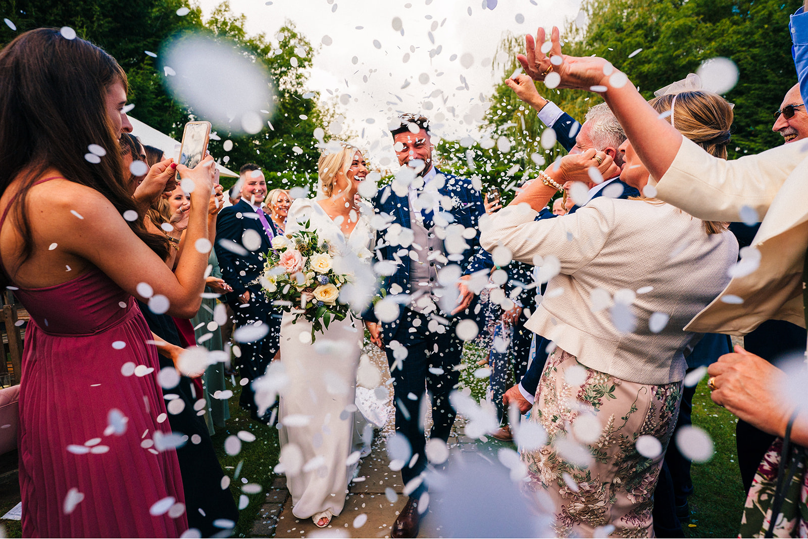 The Chequers Inn Wedding Photography - bride and groom get covered in confetti
