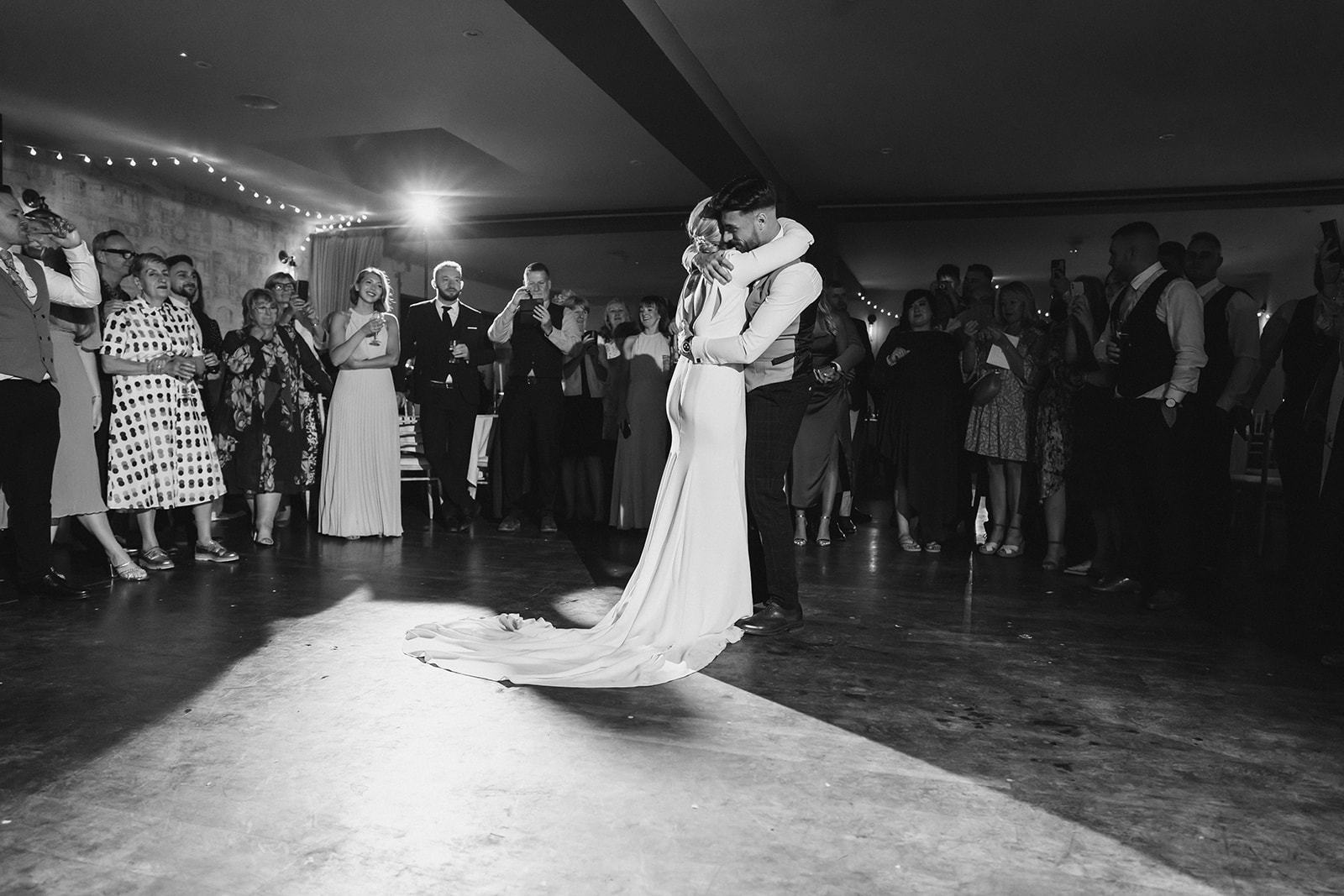 The Chequers Inn Wedding Photography - the bride and groom embrace during the first dance