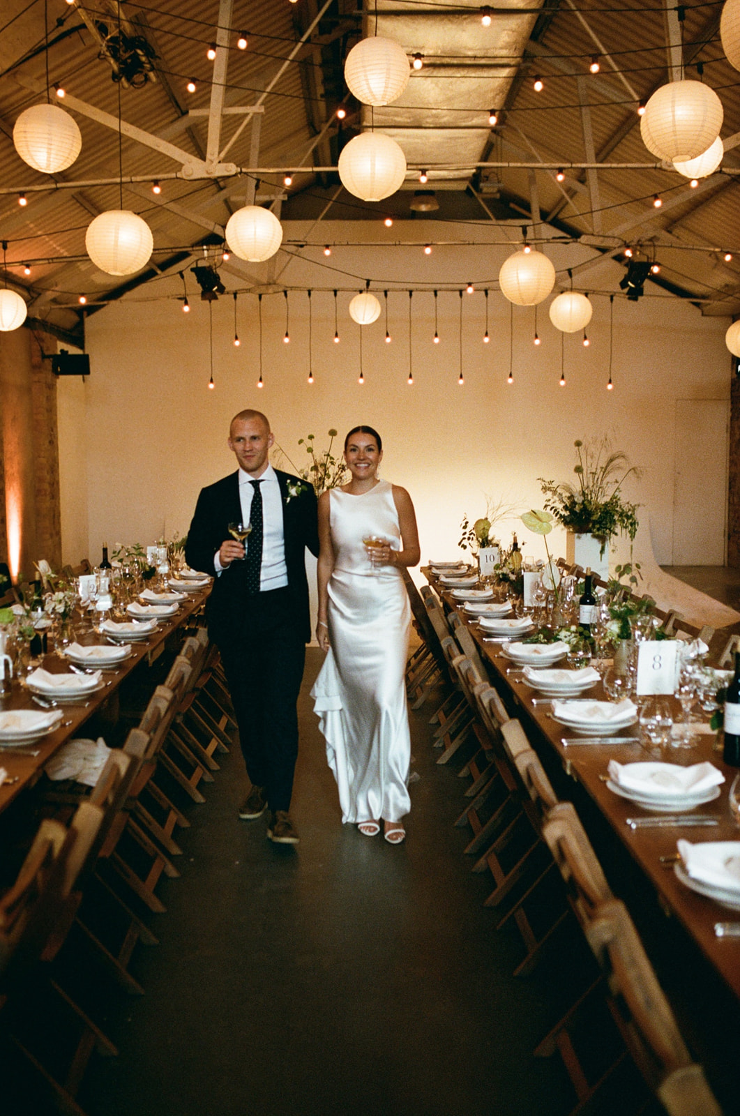 stylish couple admire the Shoreditch Studios wedding venue before their london wedding, captured on 35mm film camera