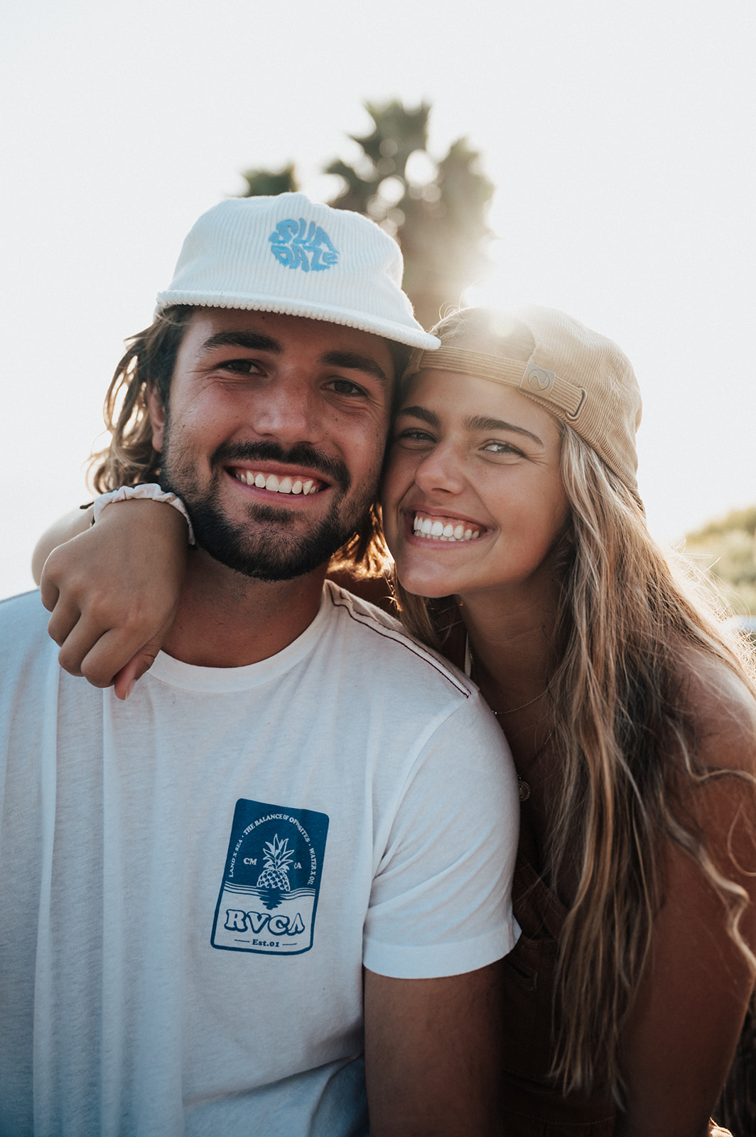 california couple smile during a beachy couples session