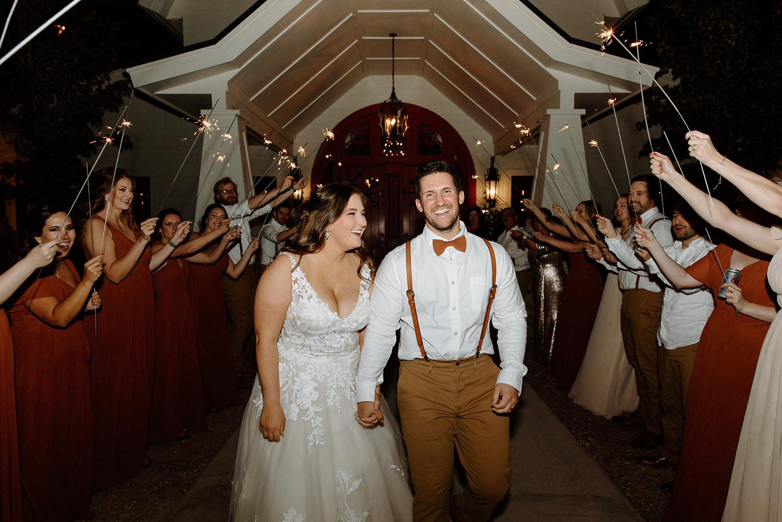 Bride and groom walk through sparklers