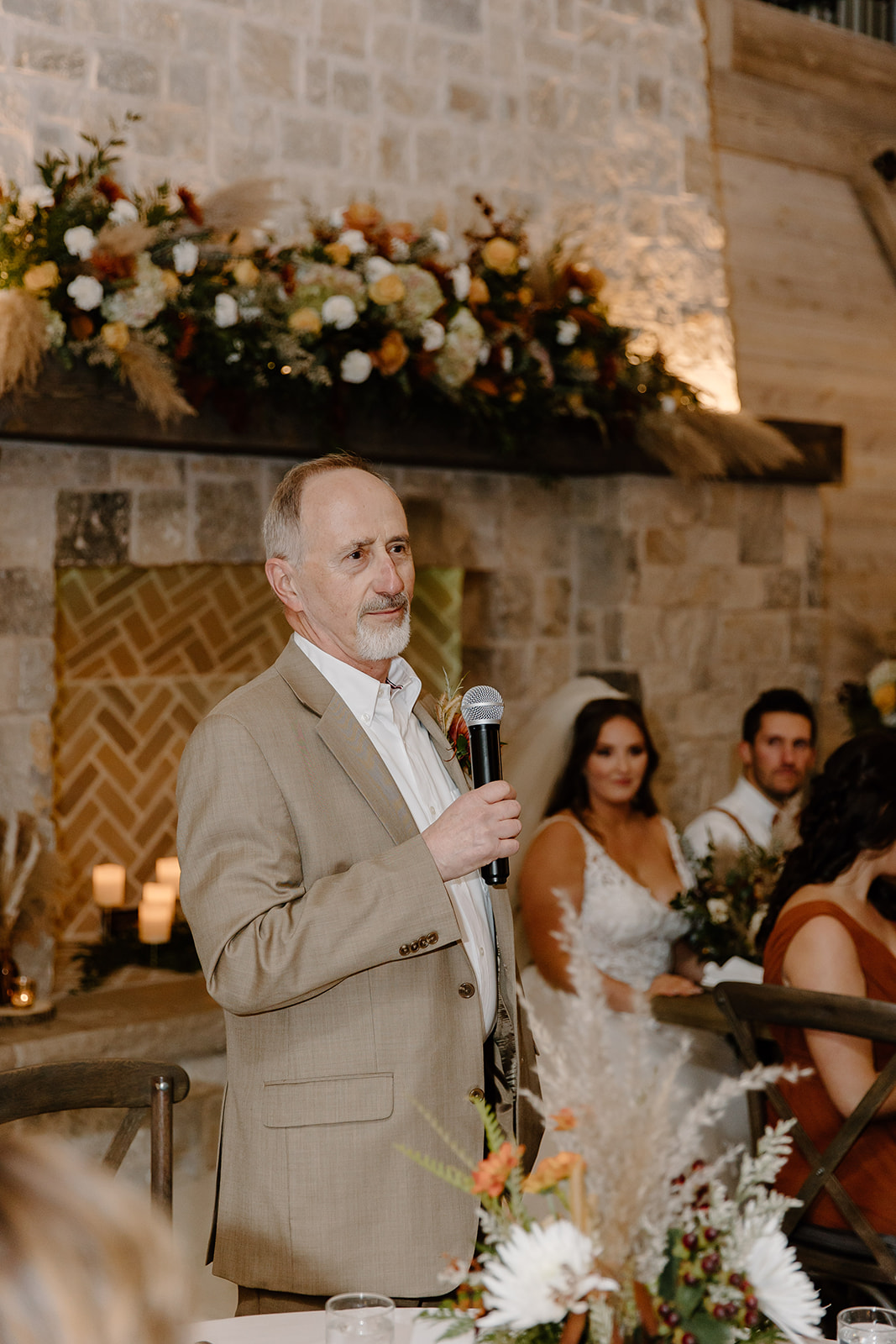 Father greets guests in front of the bride and groom