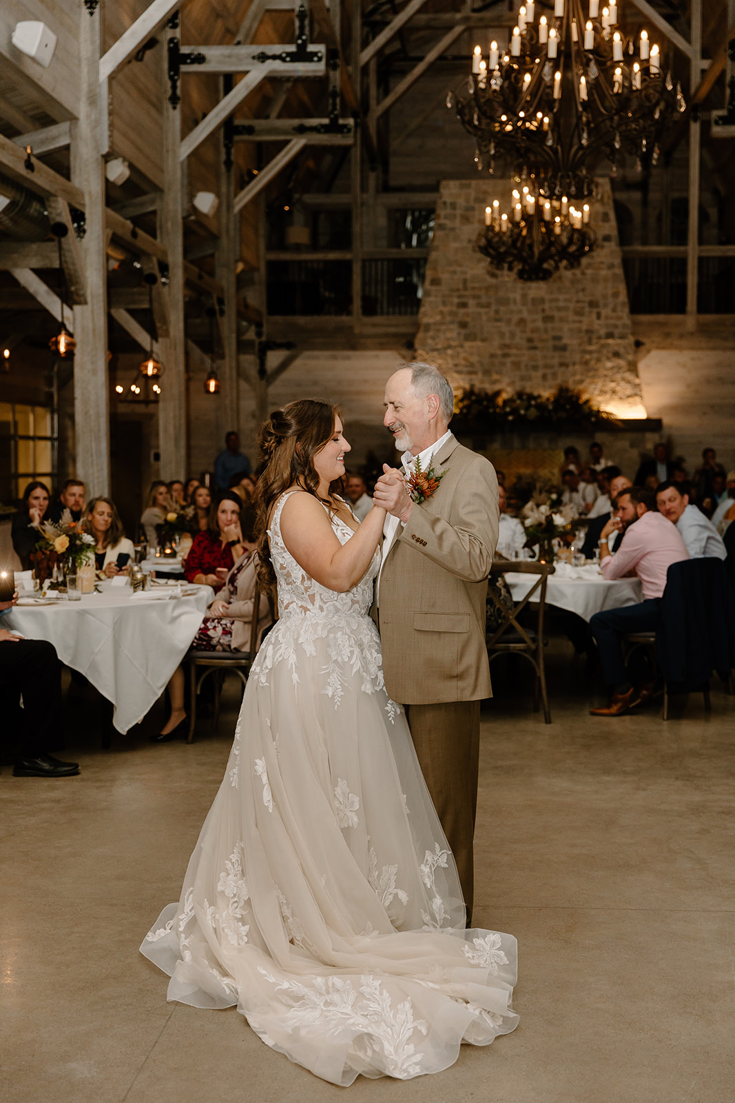 Bride and father dance in front of their guests