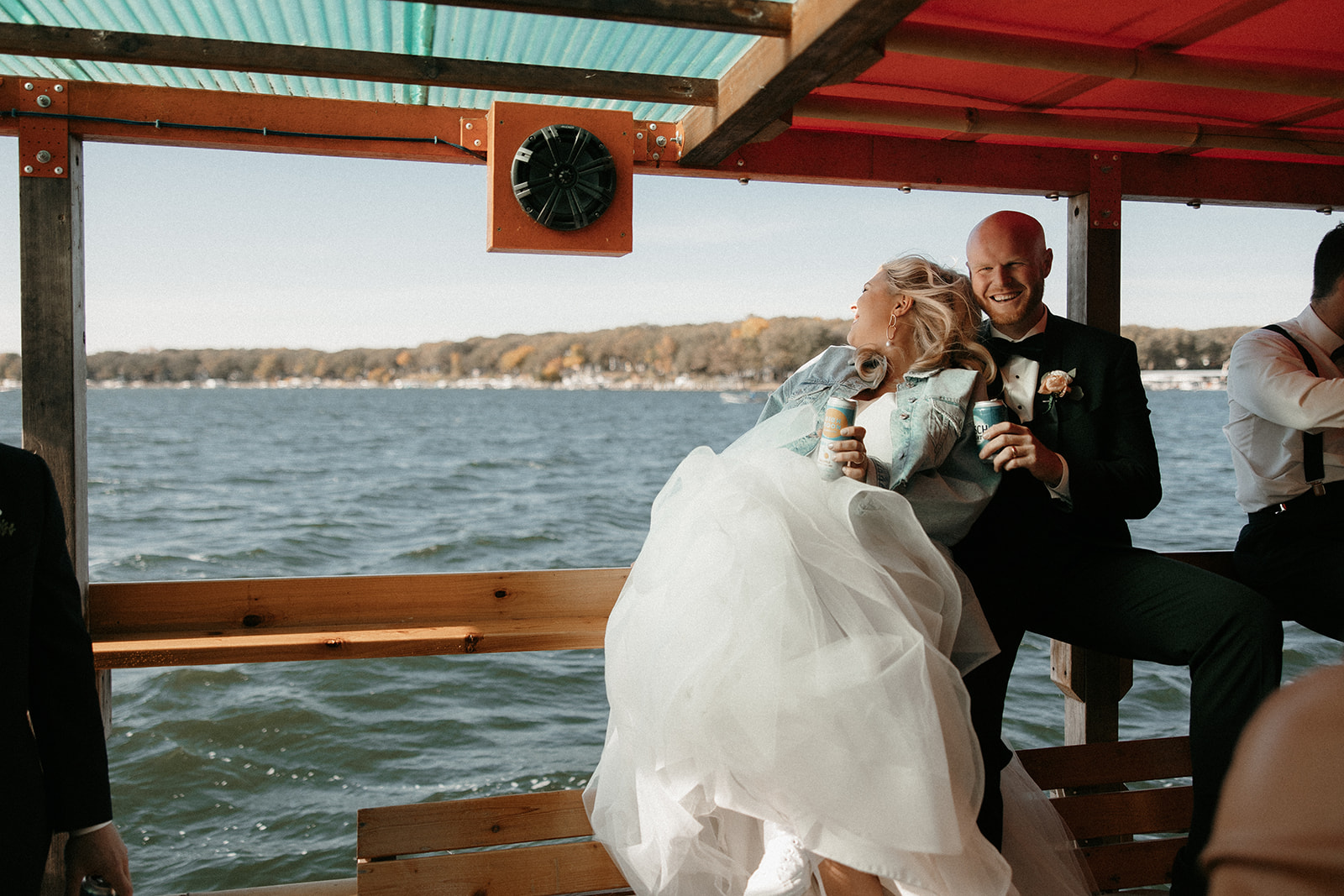 A bride and groom share time on a party boat in Okoboji, Iowa.