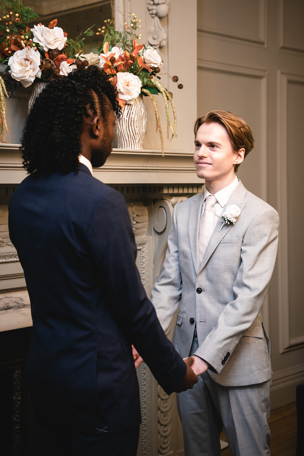 Benjamin and Ezekiel exchanging vows during the wedding ceremony in the Soho Room at Marylebone Town Hall