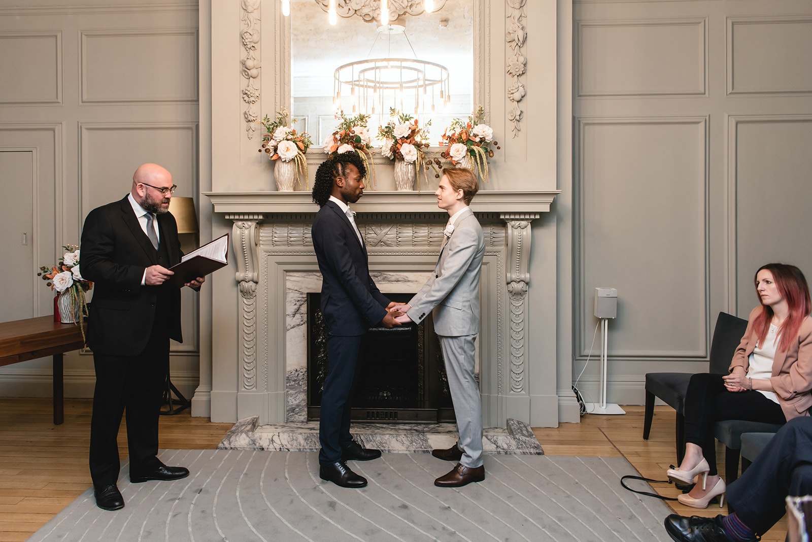 Benjamin and Ezekiel exchanging vows during the wedding ceremony in the Soho Room at Marylebone Town Hall