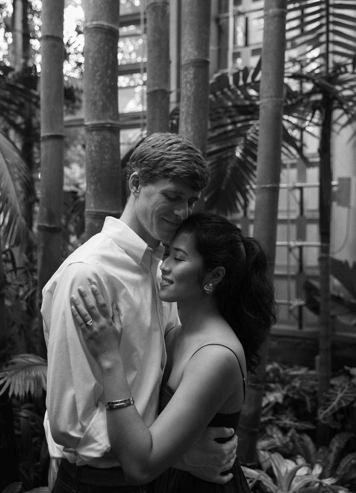 a couples engagement photos in tropical greenhouse atlanta, bamboo