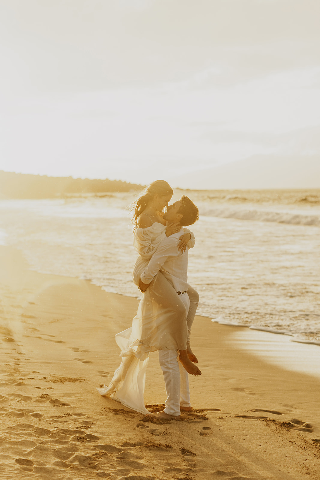 A couple who eloped in Maui enjoy their Hawaii sunset wedding photos after their Kaanapali beach elopement 