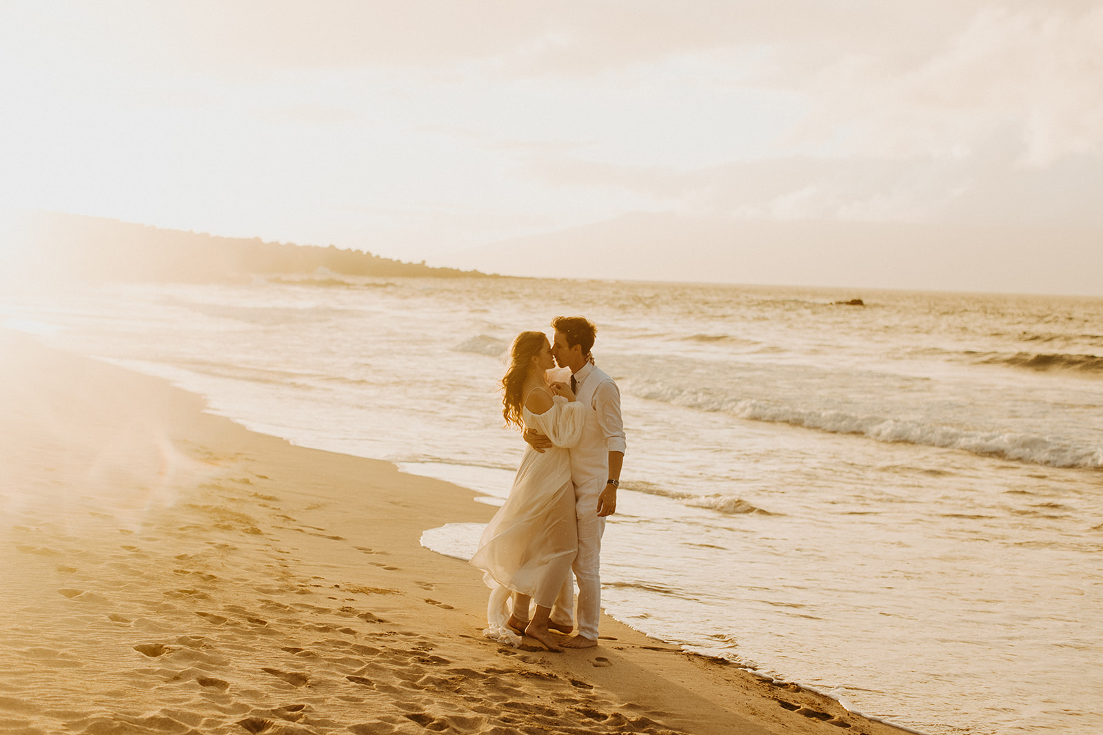 A couple who eloped in Maui enjoy their Hawaii sunset wedding photos after their Kaanapali beach elopement 