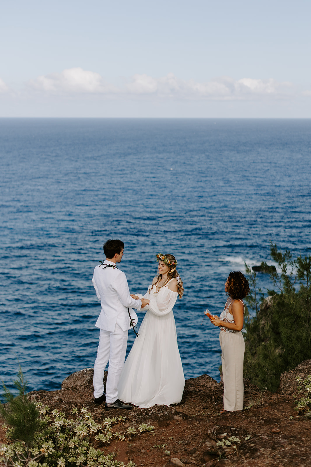 A couple who eloped in Maui say their vows during a hawaii cliffside wedding ceremony by the ocean 