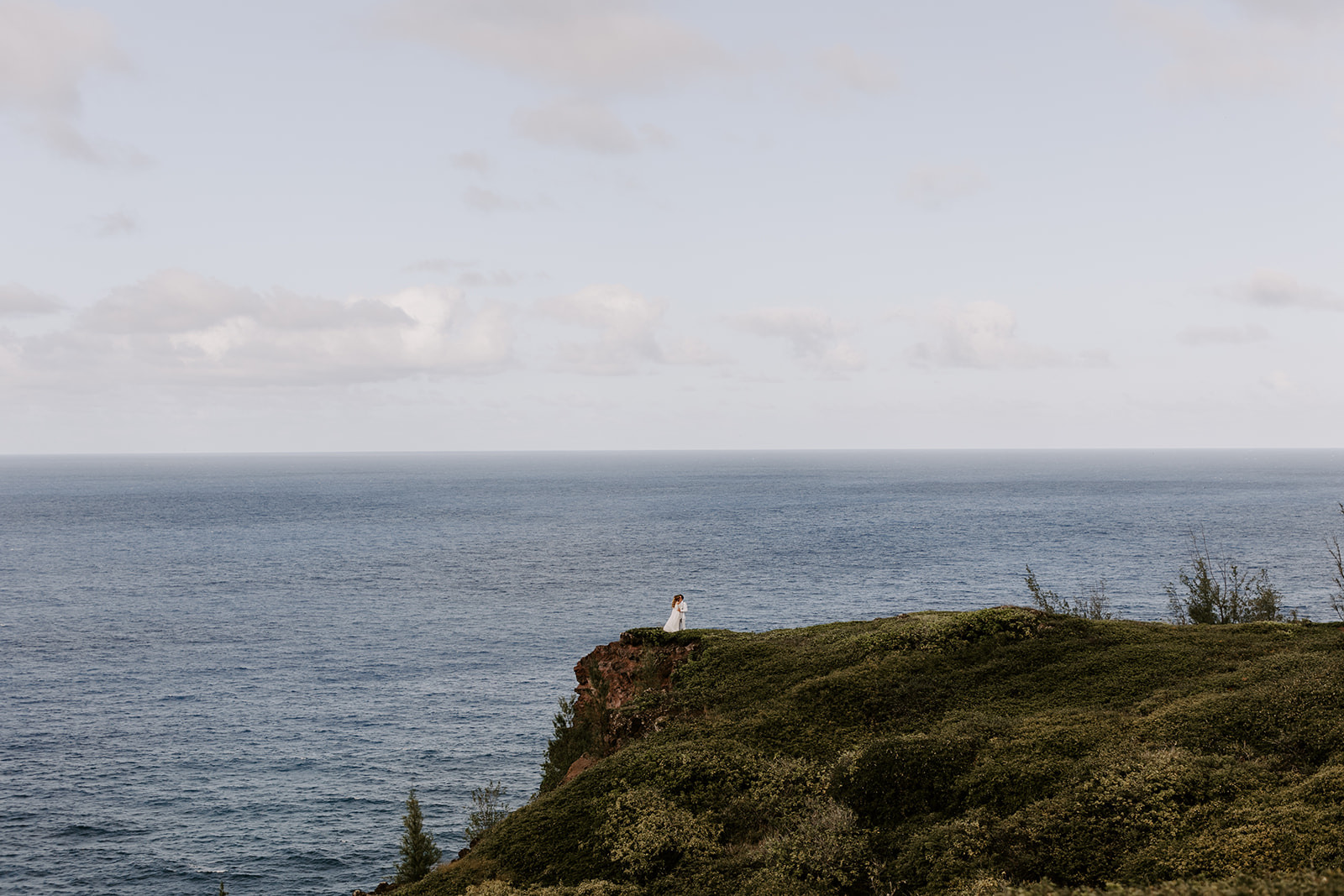 A couple who had a Maui elopement say their vows during a Hawaii cliffside wedding ceremony by the ocean 