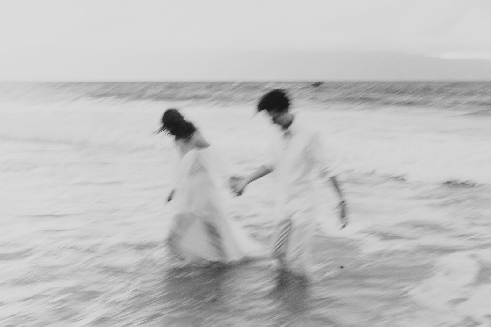 A couples runs into the ocean for their Hawaii trash the dress session 