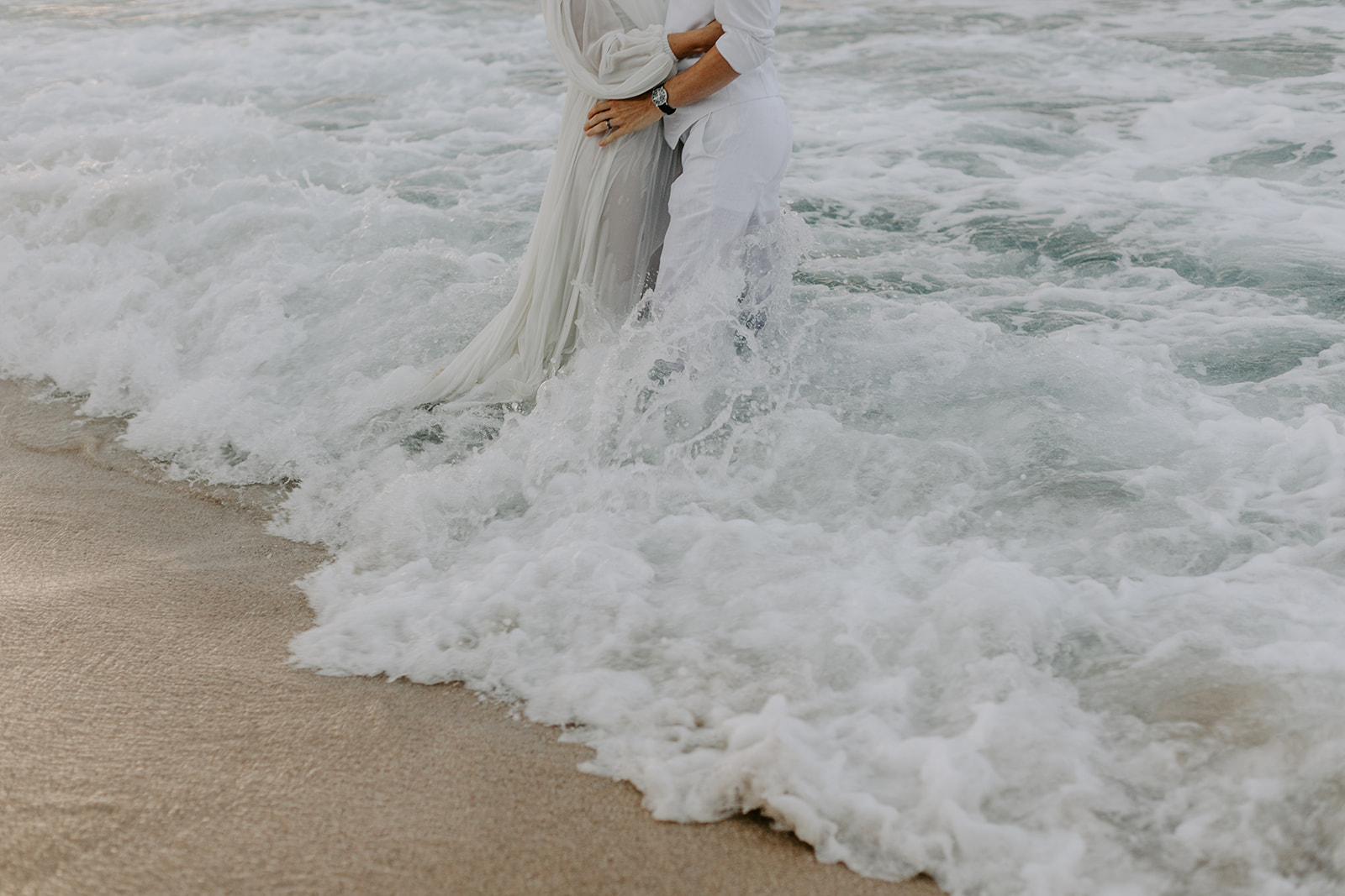 A trash the dress session for a couples in Hawaii who exchanged their vows on the beach 