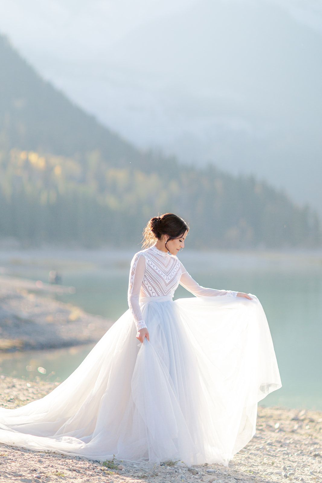 A breathtaking backlit image of a bride-to-be captured at Barrier Lake in Kananaskis Country