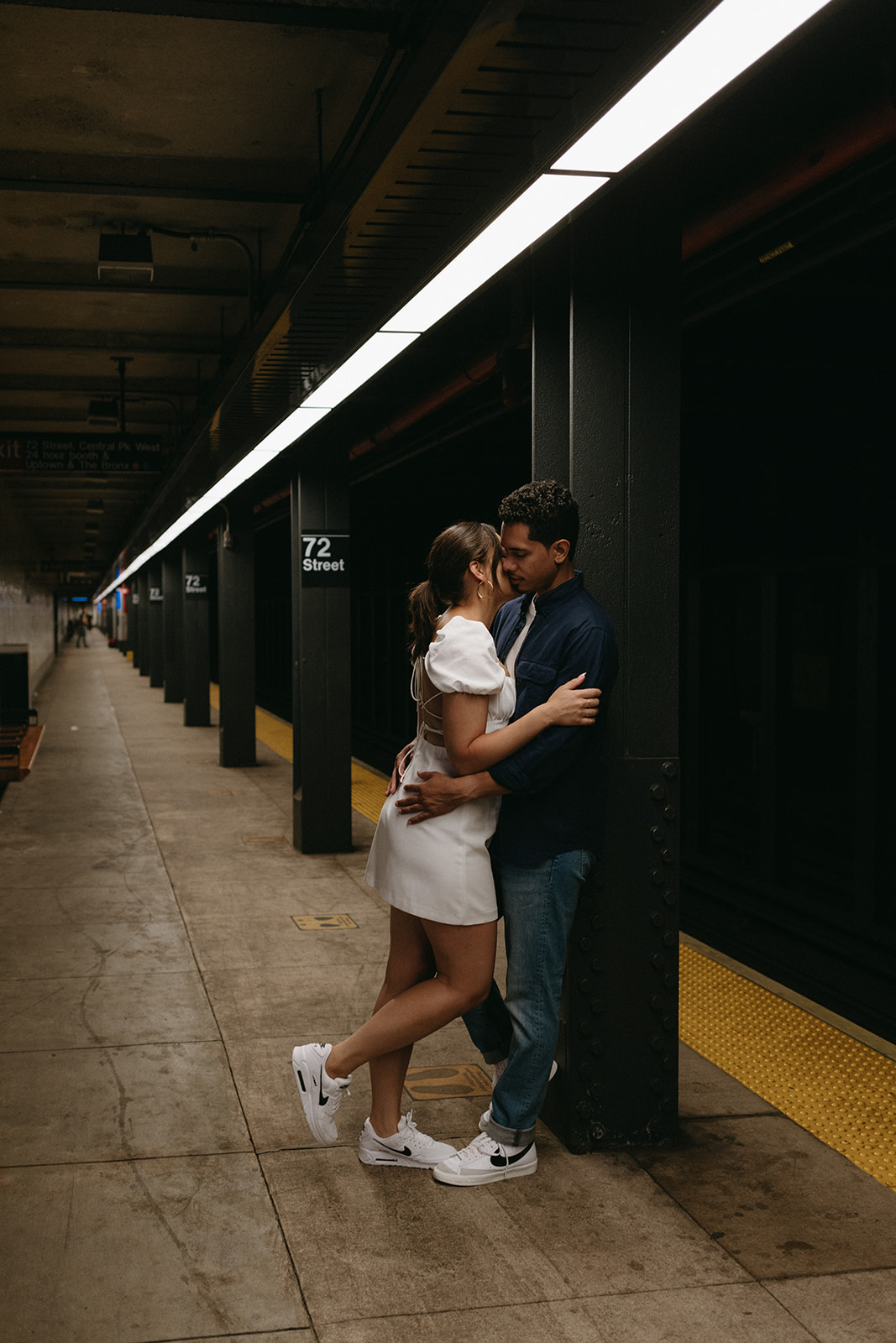 couple kissing tenderly in subway station captured by Ellie Mae Photo