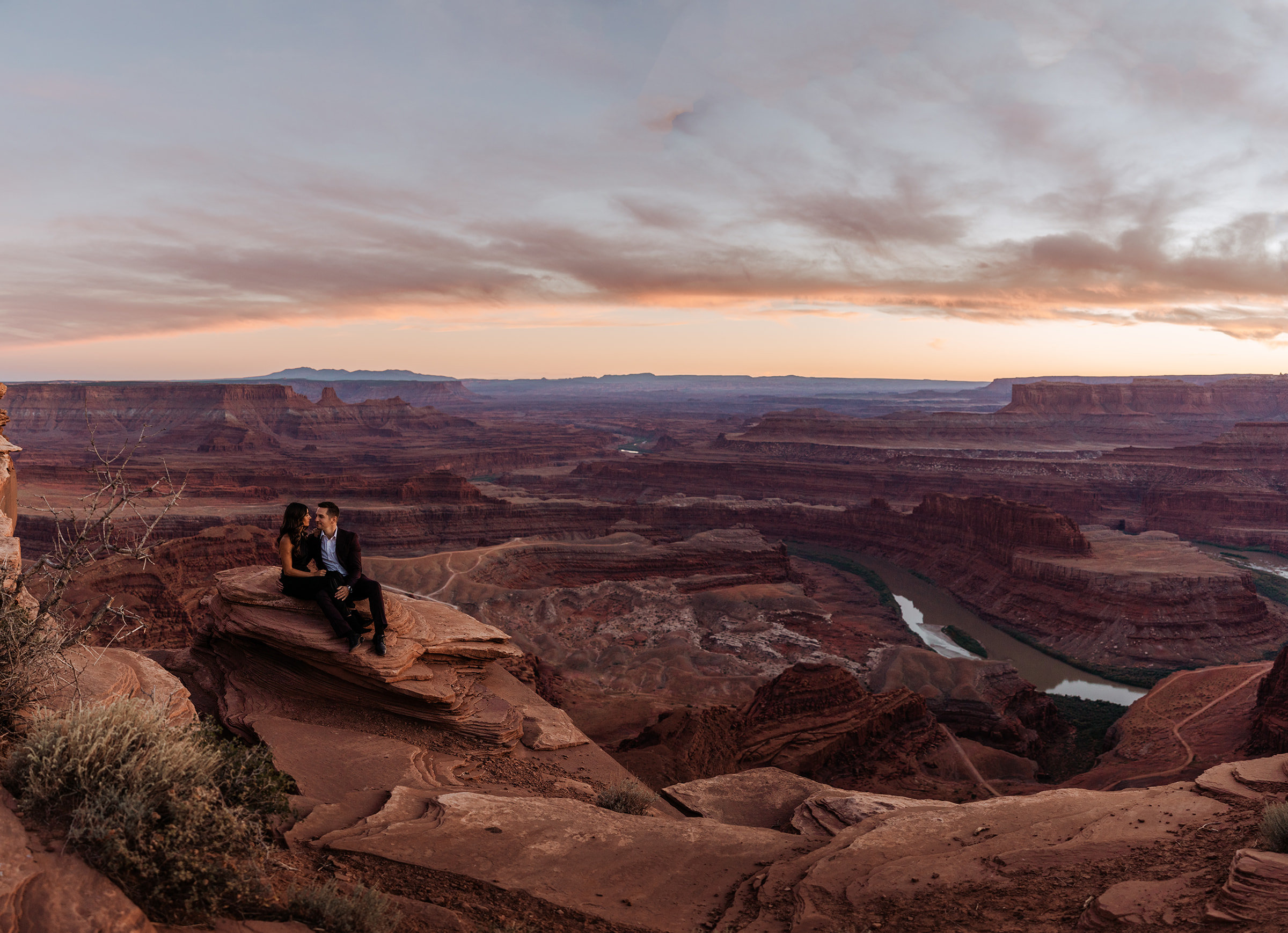 couple on a cliff overlook in moab