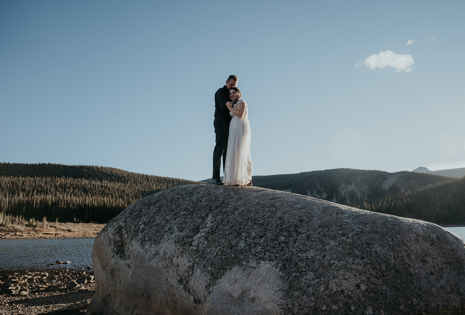 Couple embraces on giant boulder during an elopement in Colorado 