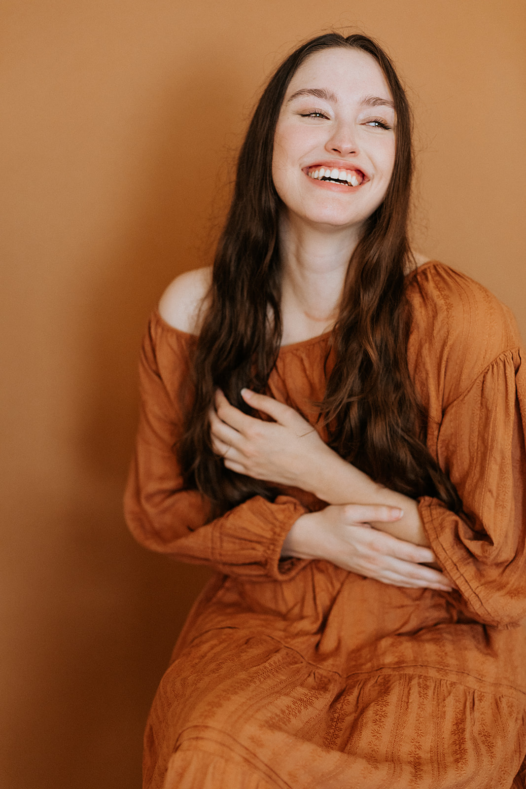 Portrait of women with long brown hair on a neutral background