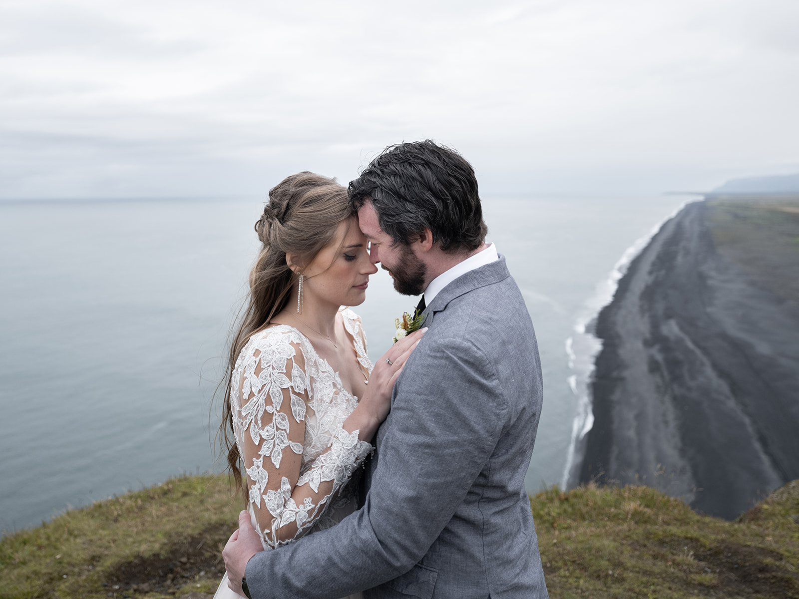 bride and groom enjoying the view at Dyrholaey lighthouse on their elopement day.