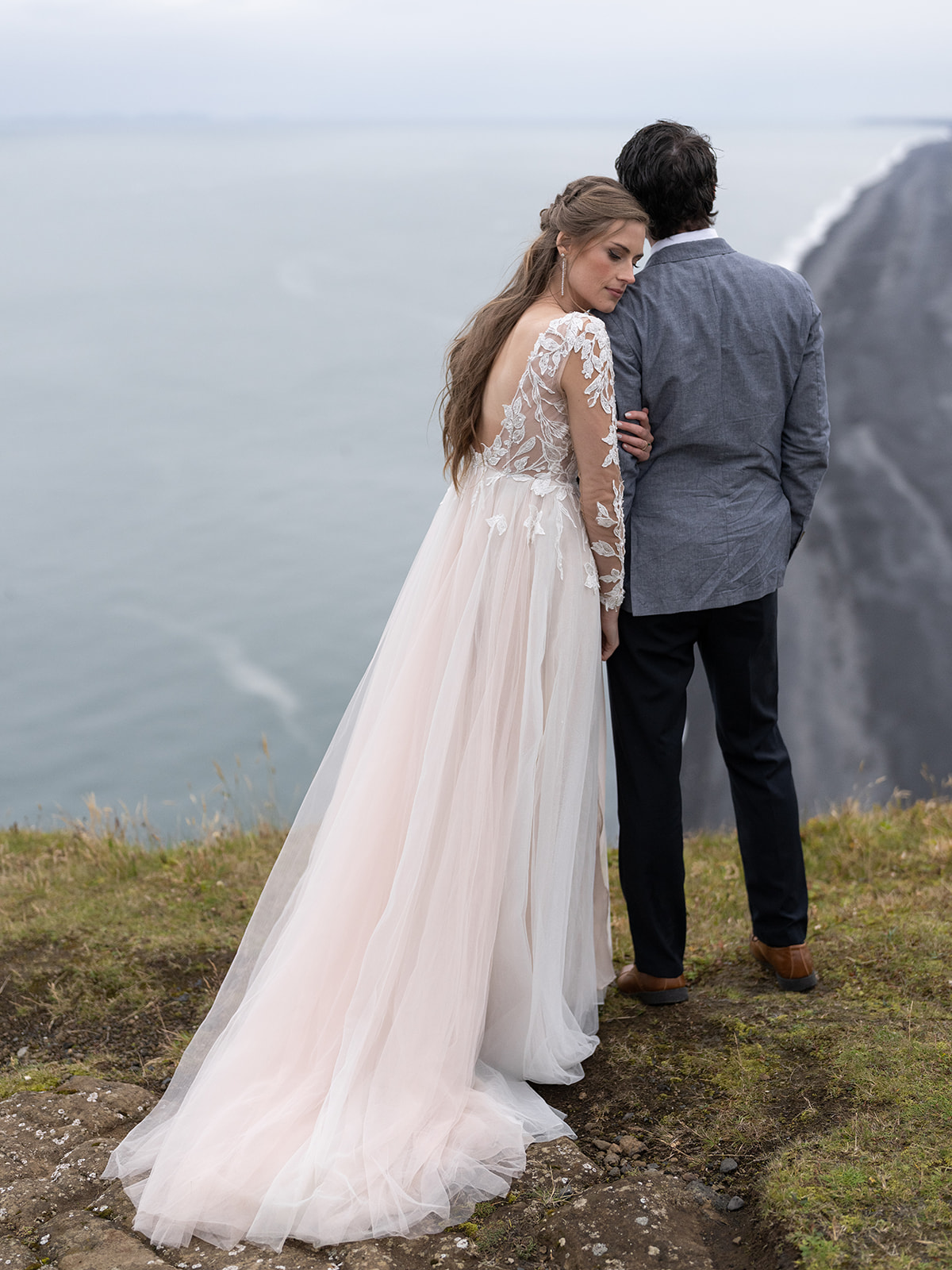 bride and groom enjoying the view at Dyrholaey lighthouse on their elopement day.
