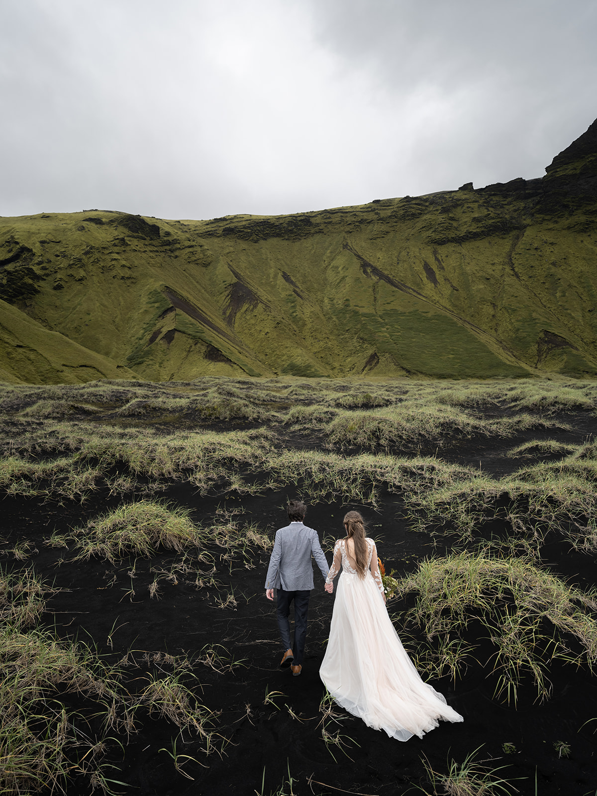 black sand mounds and long green grass are featured in this iceland elopement 
