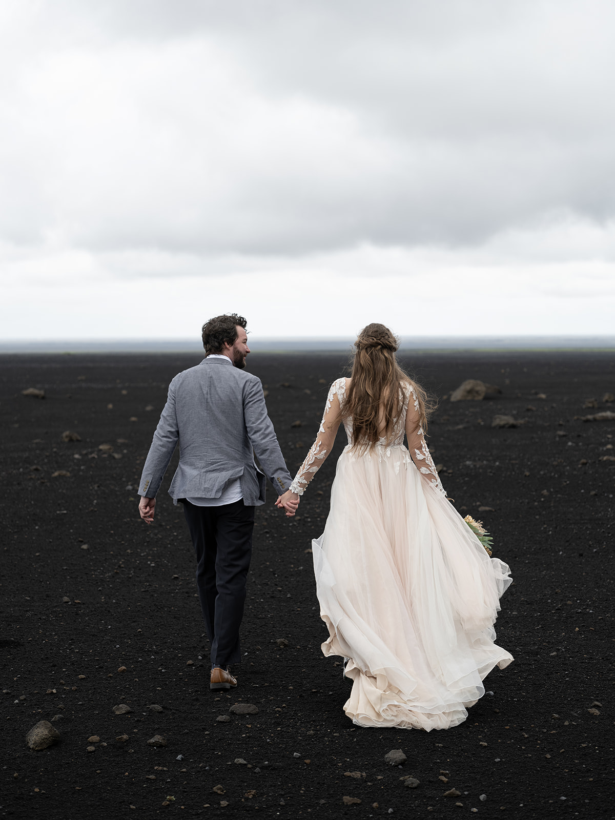Bride and Groom on a black beach in iceland during their elopement 