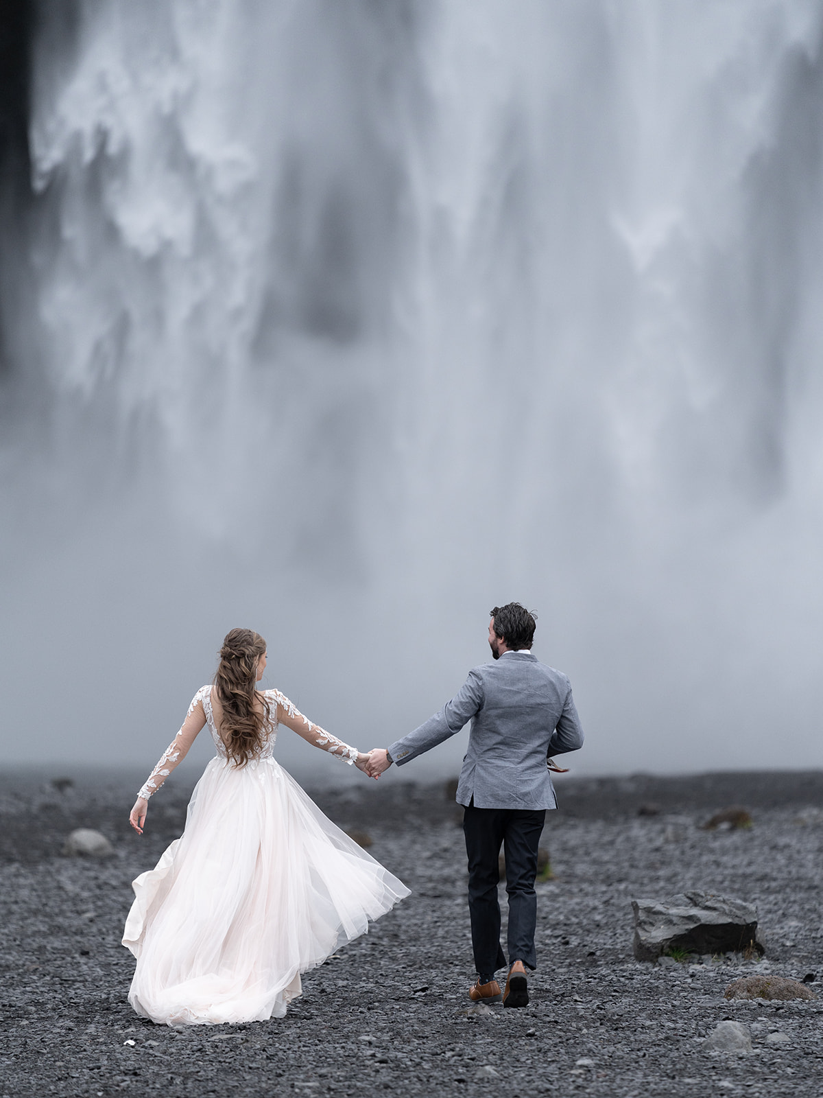 Couple eloping in Iceland at Skogafoss waterfall