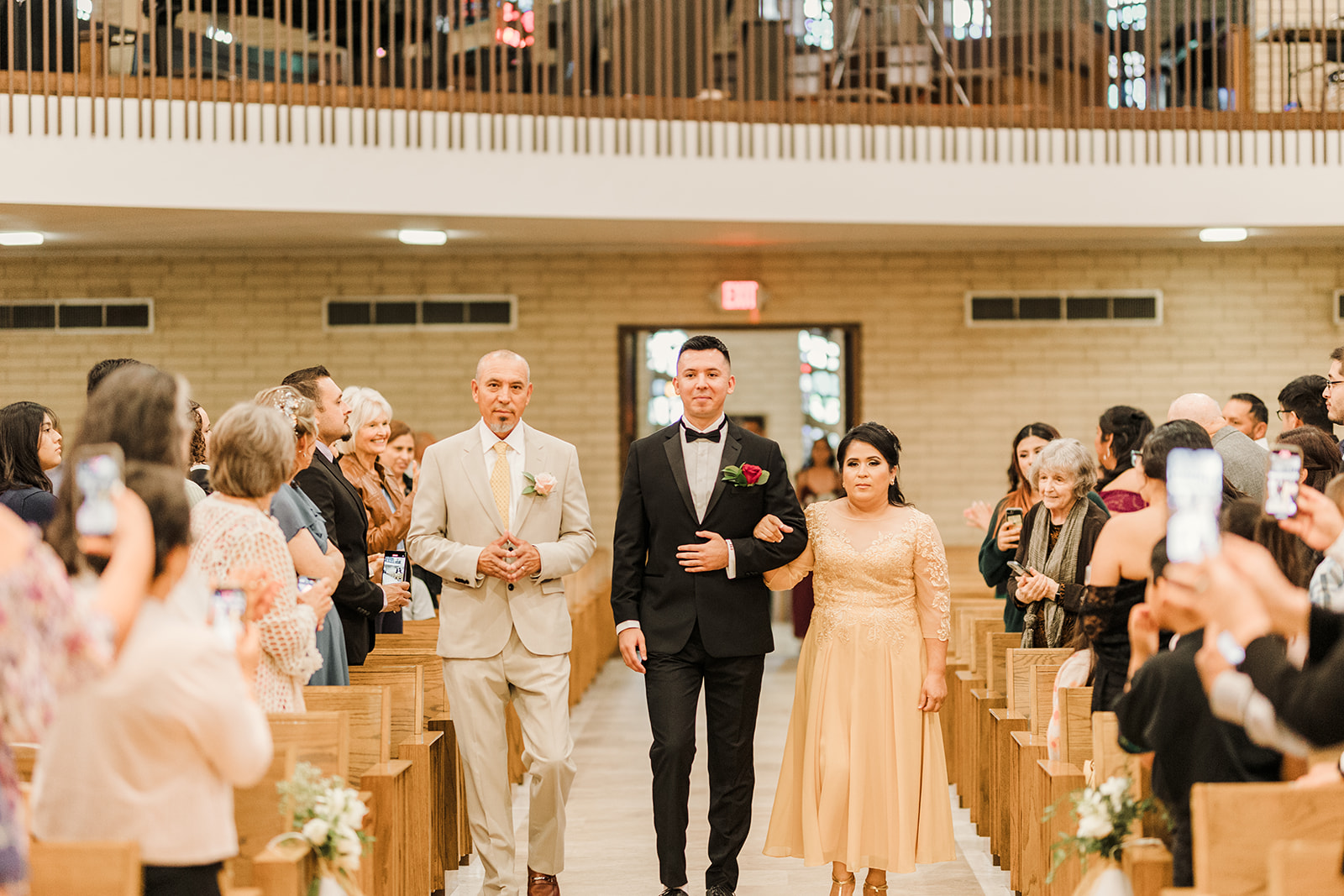 Groom and parents walking down the isle at Saint Mary's catholic church in Fullerton California