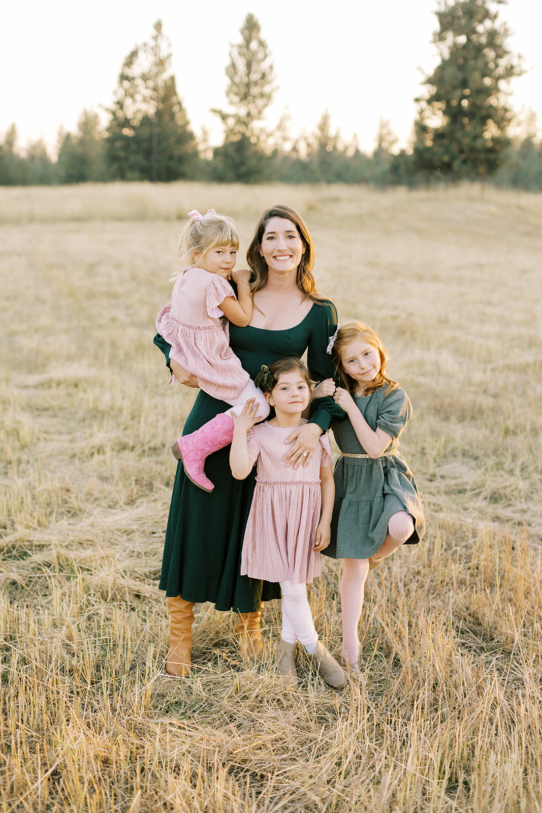 Mother with three daughters portrait in open field at sunset in Spokane, Washington.