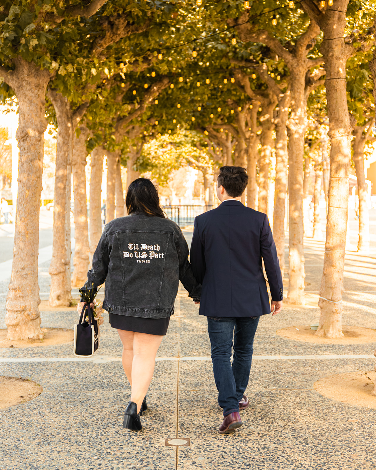 engaged couple custom jacket walking trees