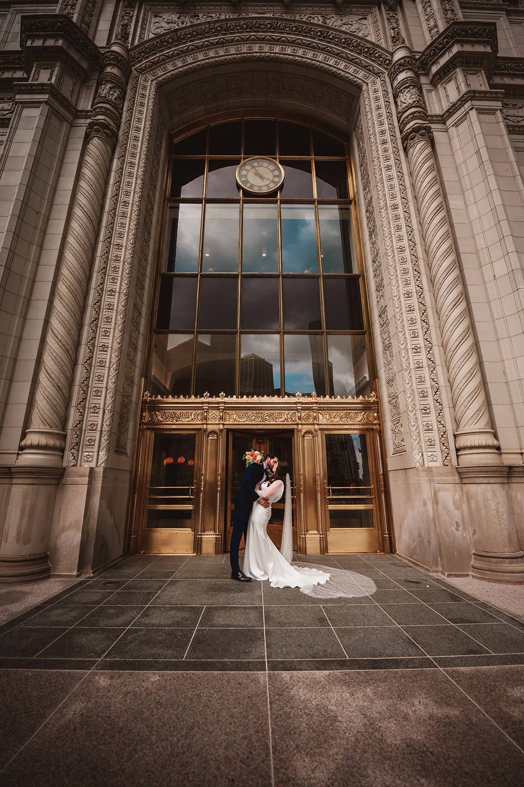Bride and groom in front of the Wrigley building in Chicago