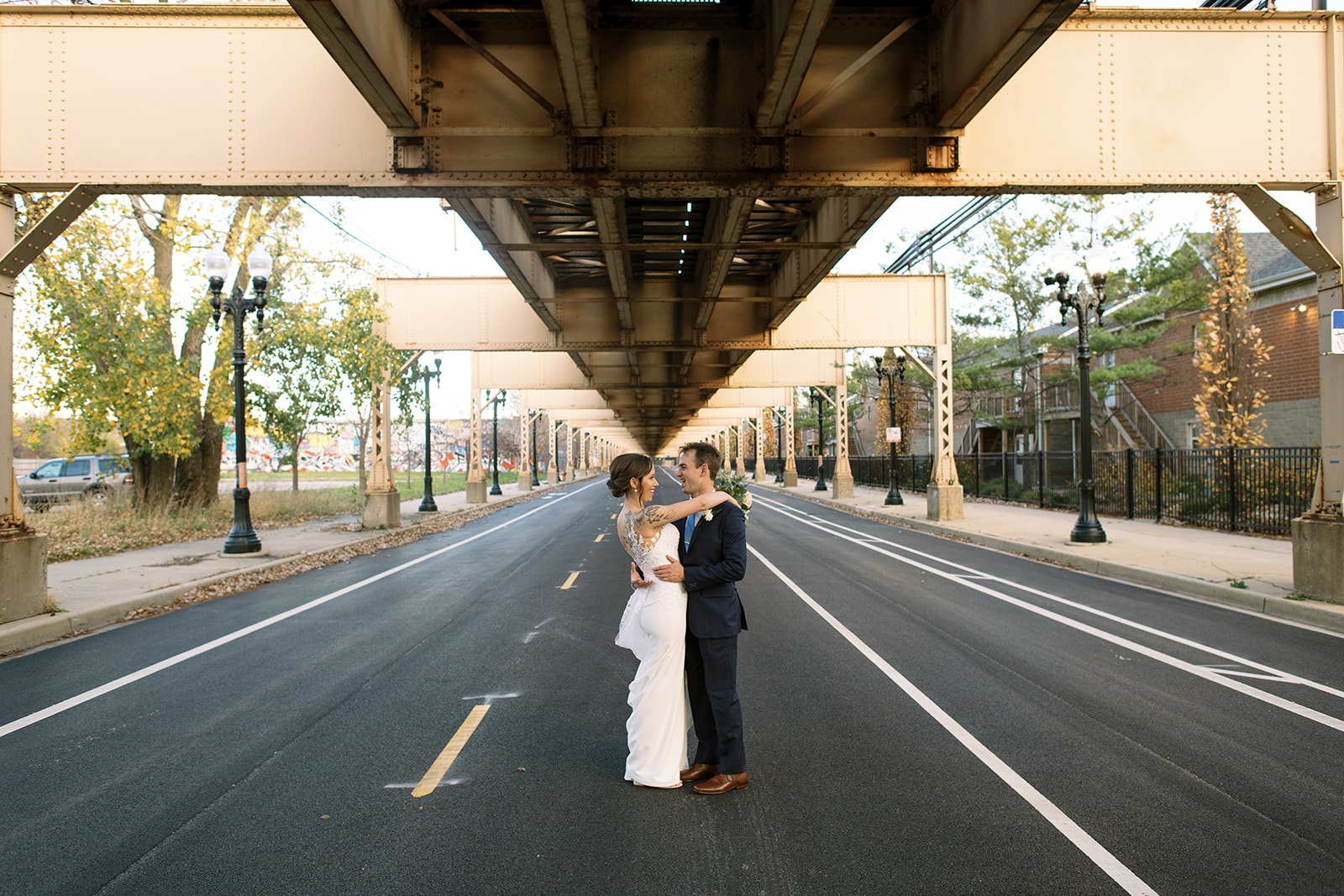 Bride and groom below train in chicago