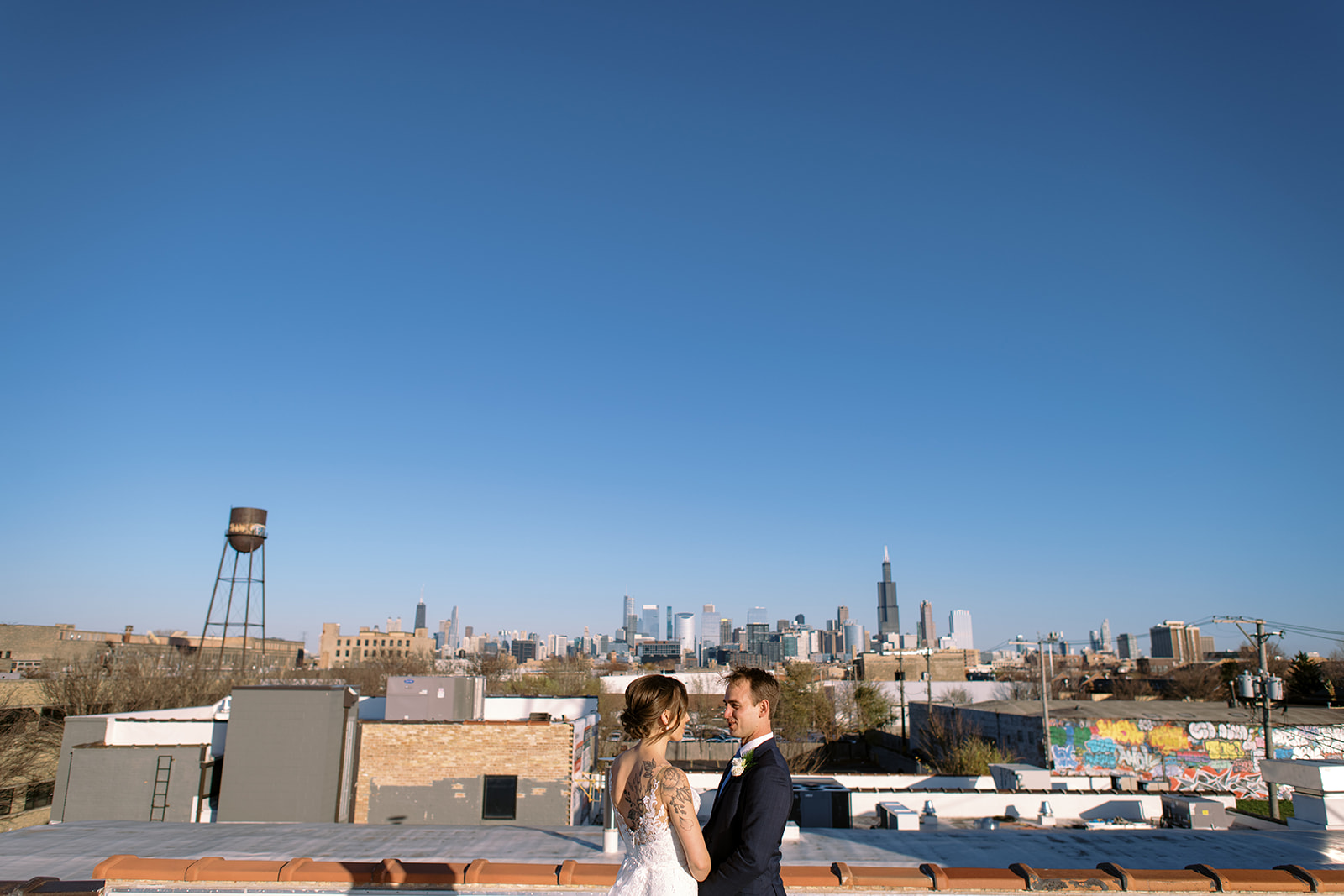 Bride and groom firstlook on rooftop of Walden Chicago with the Chicago skyline in the background