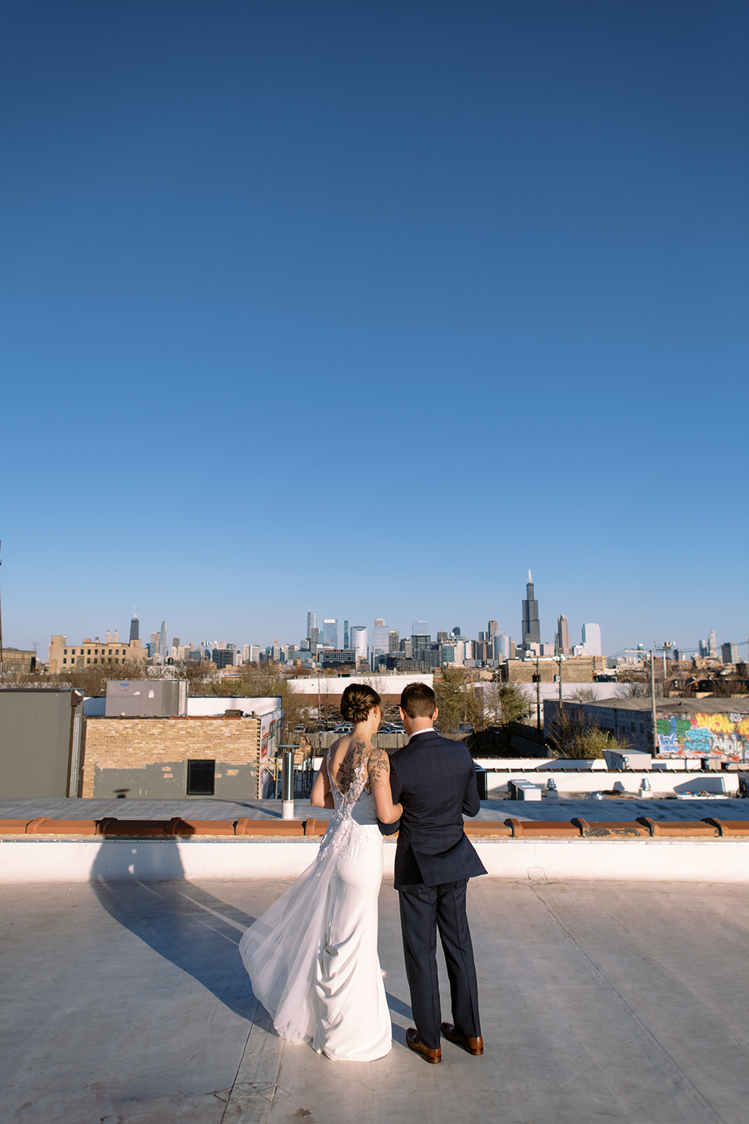 Bride and groom firstlook on rooftop of Walden Chicago with the Chicago skyline in the background