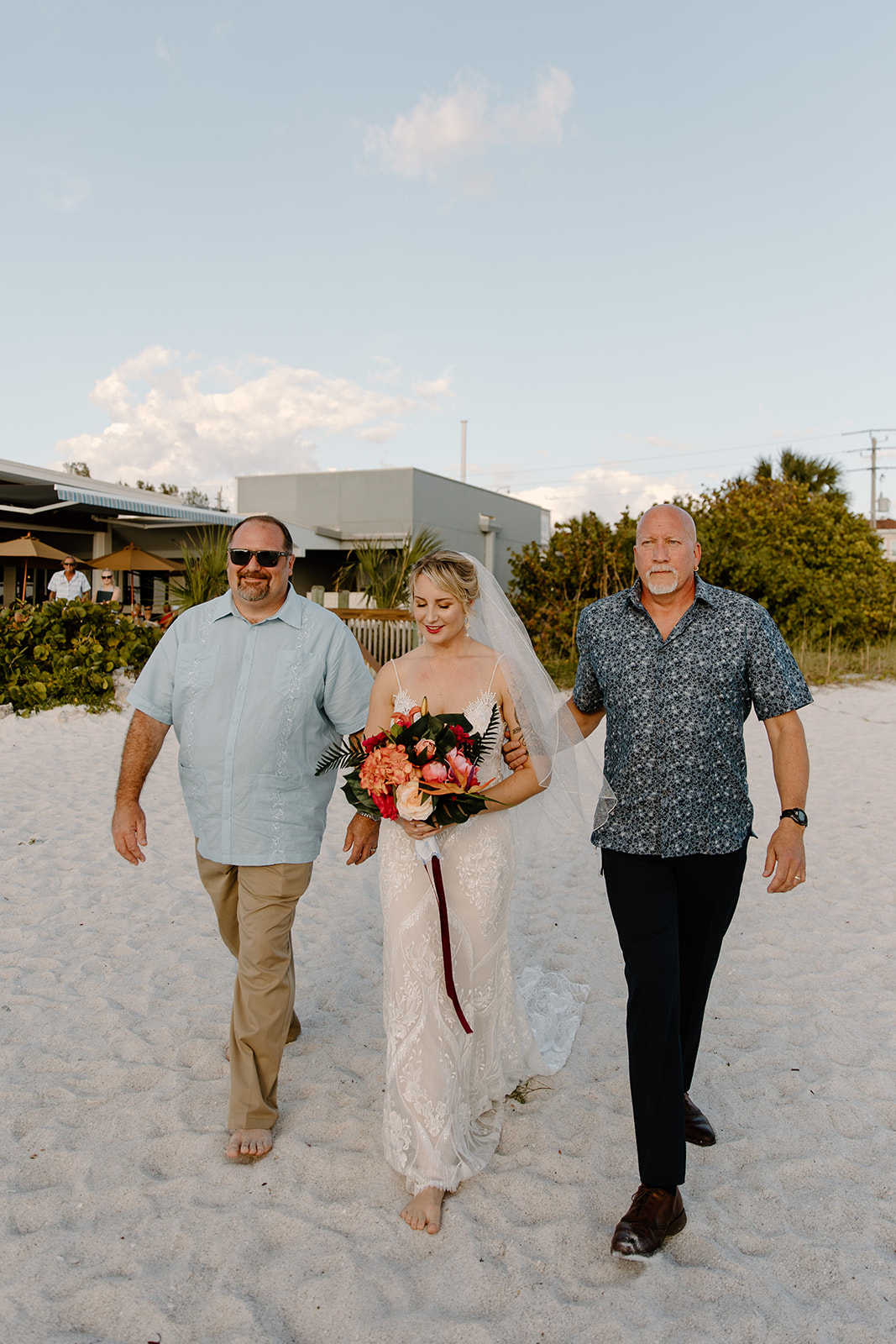 Bride walking down the aisle with her fathers