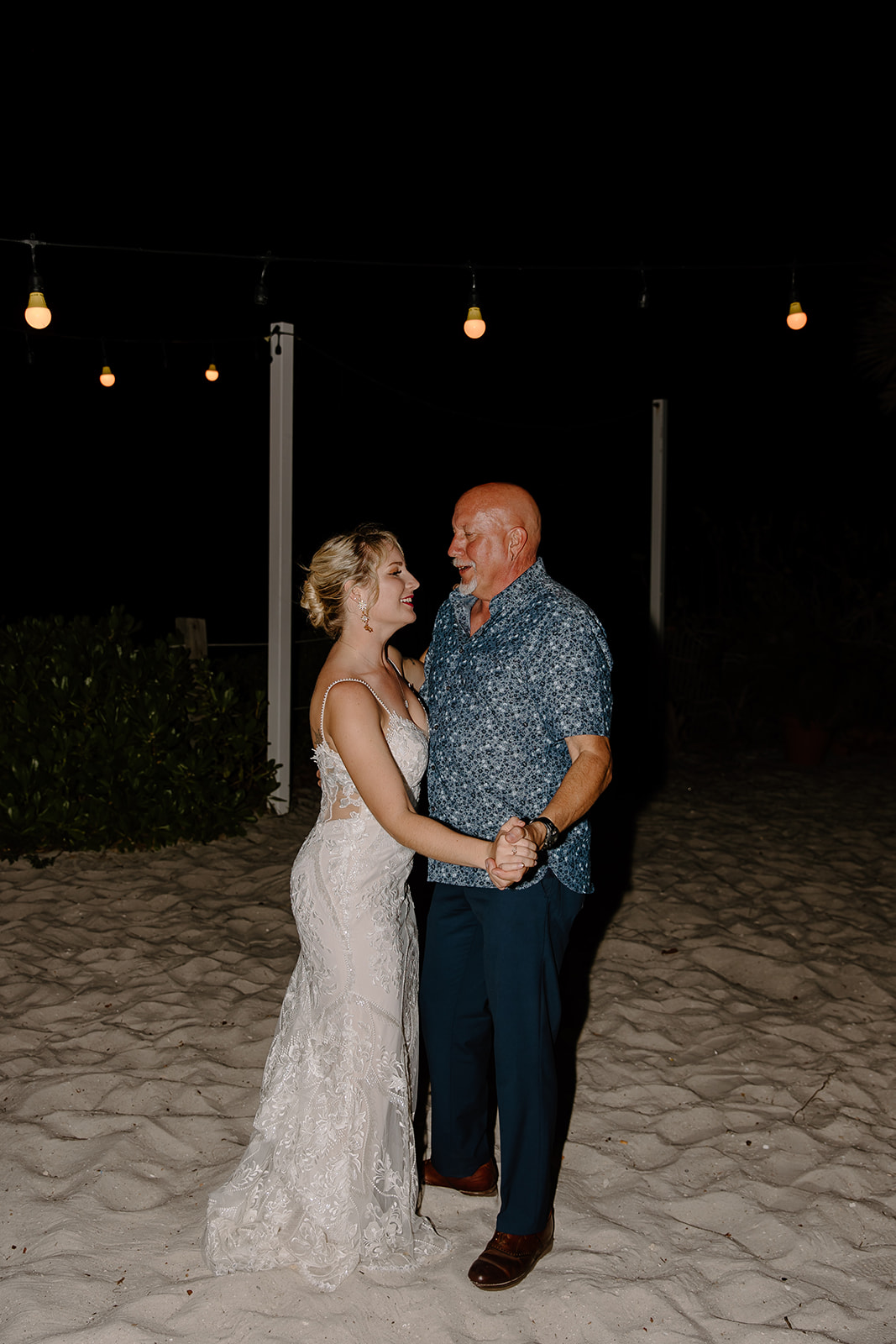 Bride dances with her father on the beach