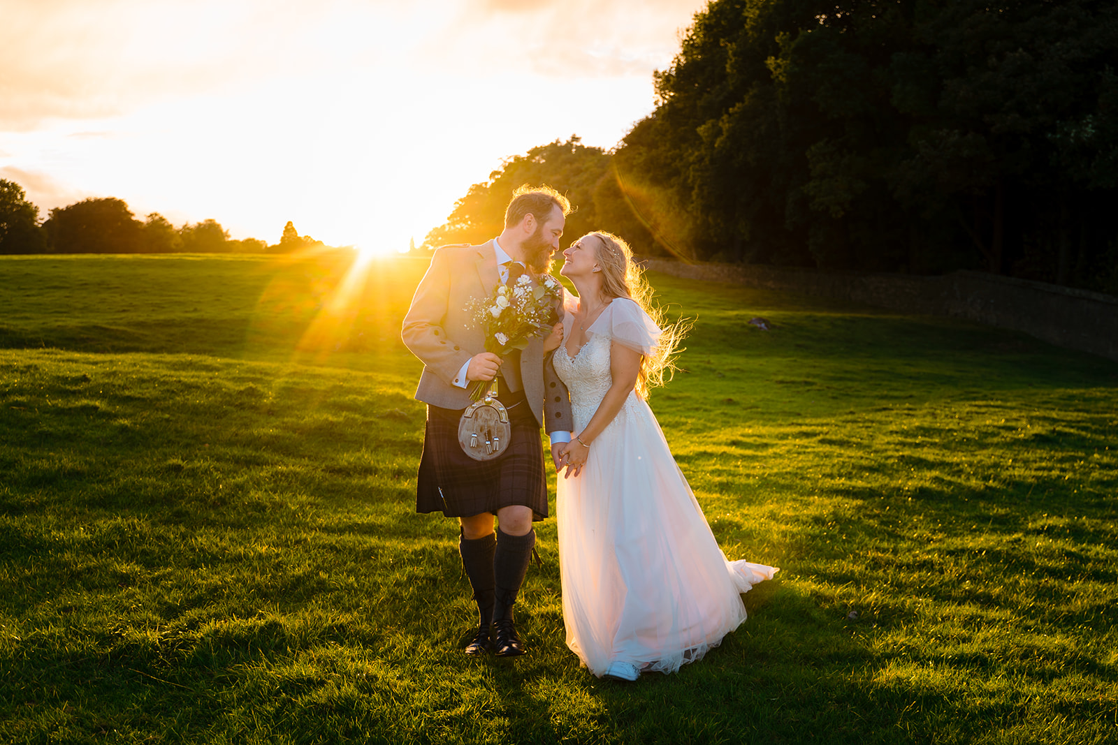 A couple who got married on the Broughton hall estate, sunset in background