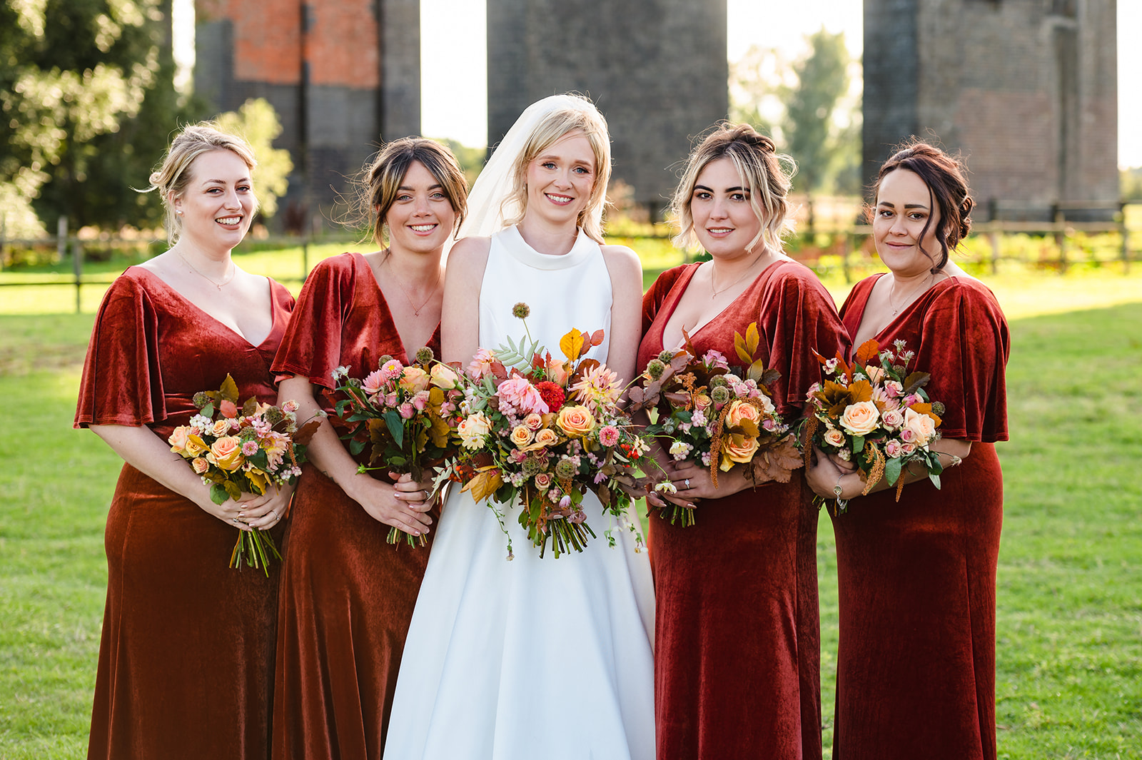 bride and her bridesmaids in their terracotta bridesmaid dresses