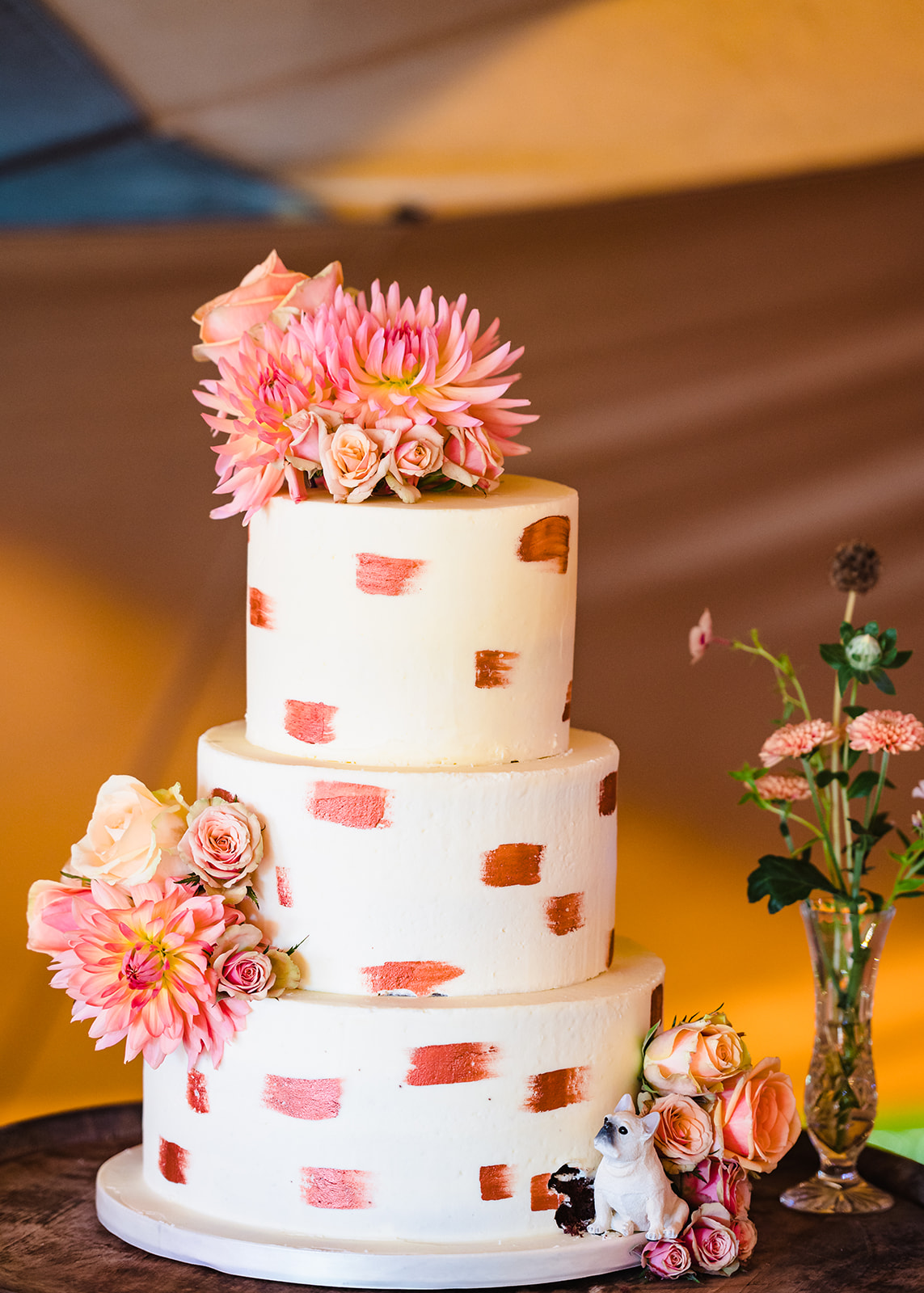 cream wedding cake with terracotta accents 