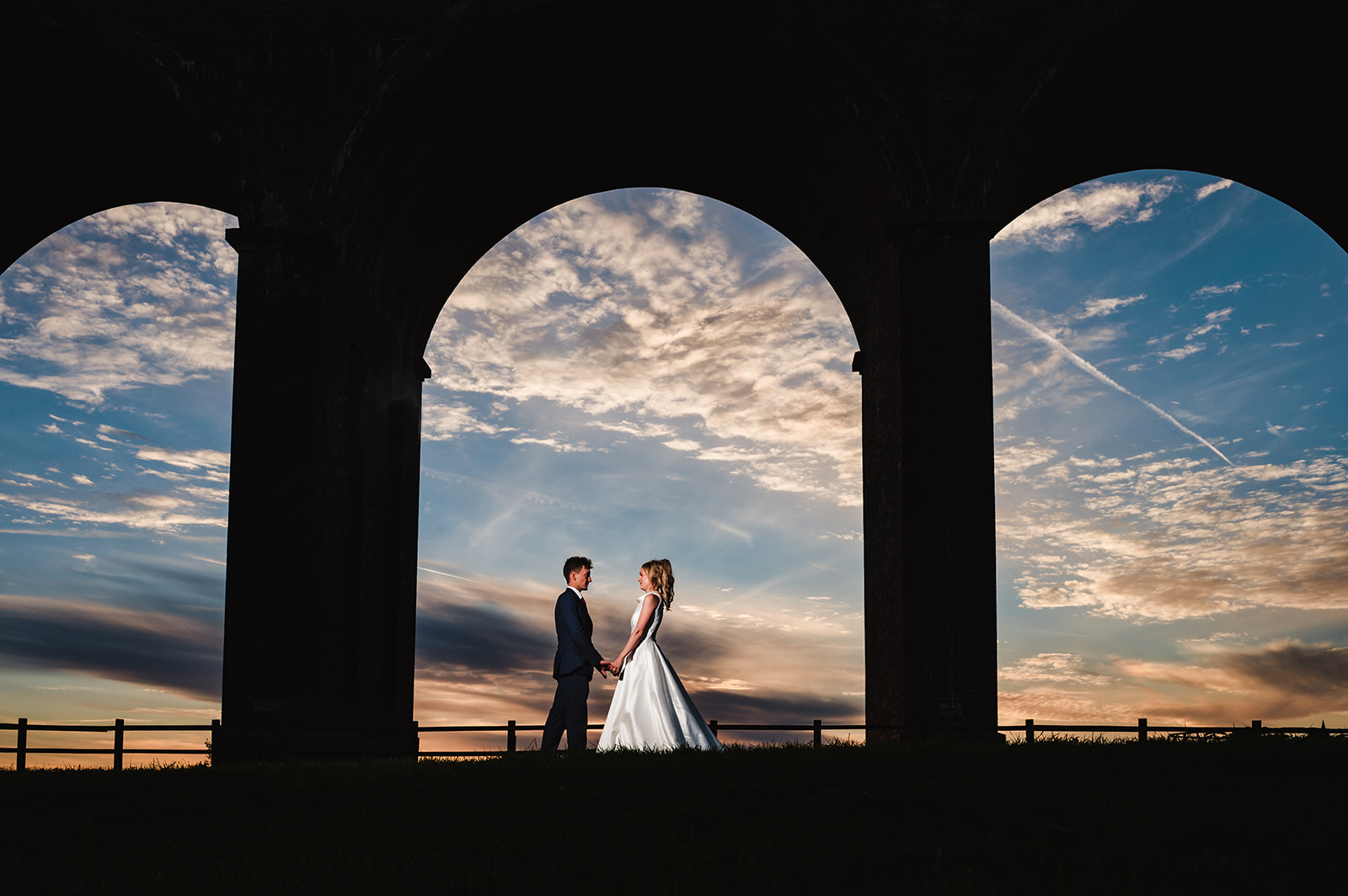 photo of a bride and groom at sunset at harringworth viaduct