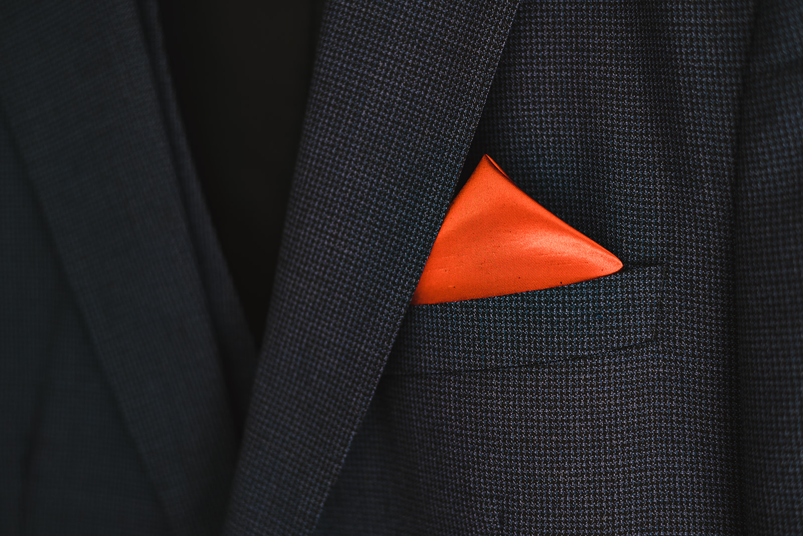 terracotta coloured pocket square with navy blue suit