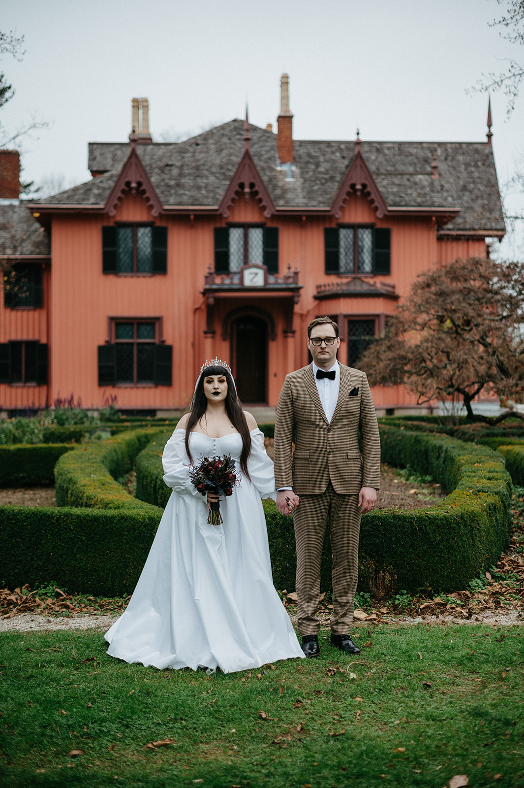 Bride and groom stand together in front of Roseland Cottage during their elopement