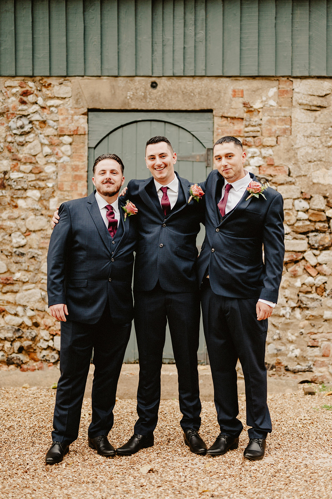The groomsmen pose for a formal relaxed photo during a pentney abbey wedding