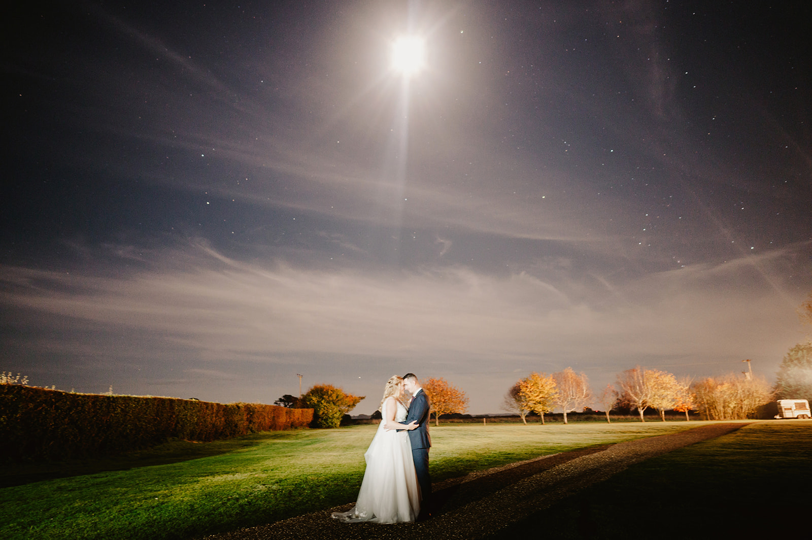 nighttime wedding portrait with the stars under the moonlight outside pentney abbey